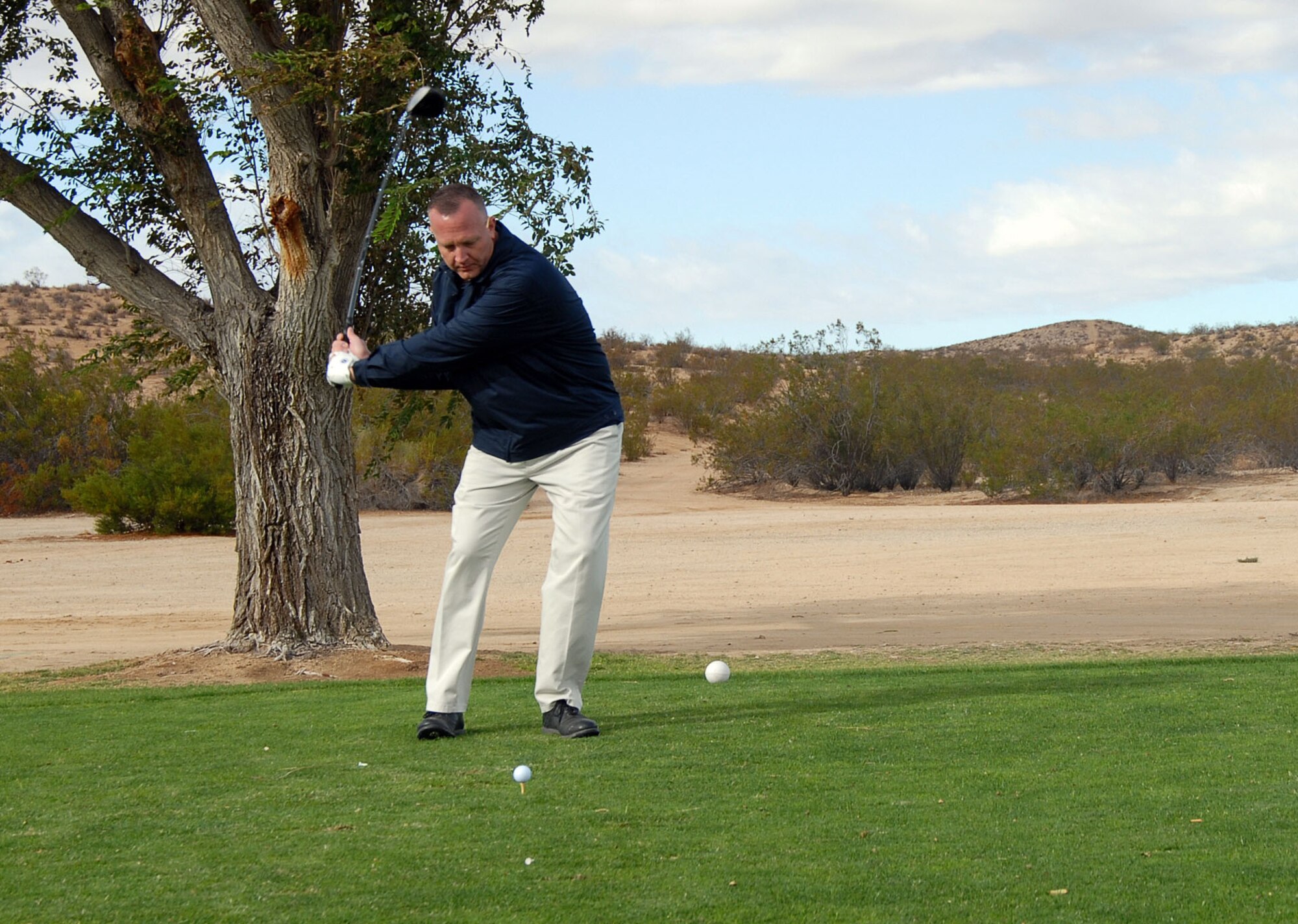 Master Sgt. Christopher Nagle, 412th Maintenance Squadron munitions flight systems superintendent, winds up for a shot at the Muroc Lake Golf Course here Oct. 5. The Air Force Sergeants Association golf tournament, which was hosted by the AFSA Spaceway Chapter, consisted of 25 players who competed in an 18-hole game and had two hole-in-one prize opportunities. (Photo by Senior Airman Jason Hernandez)