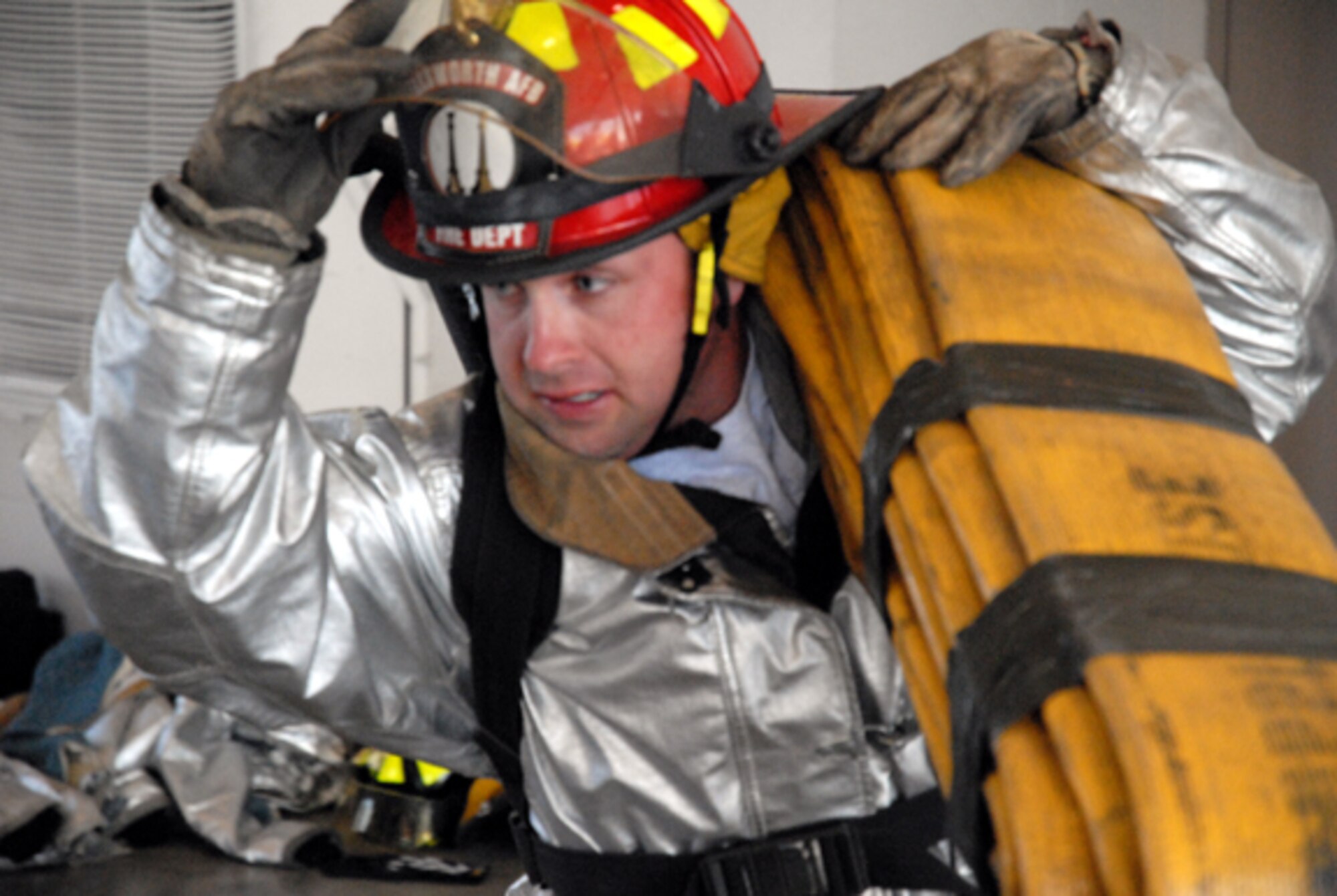 Staff Sgt. Adam Martin starts the hose carry portion of the Firefighter Challenge. Sgt. Martin's team finished  the course with a time of 5 minutes and 30 seconds. (U.S. Air Force Photo by Staff Sgt. Eric Bolt)