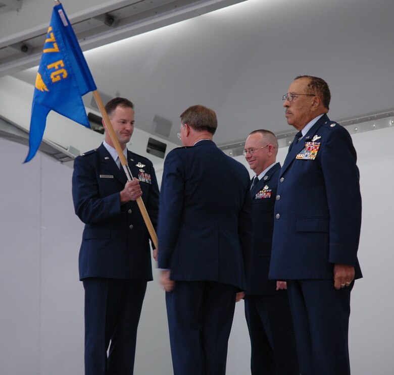 Col.  Eric Overturf, 477th Fighter Group commander, takes the guidon from Lt. Gen. John Bradley, Air Force Reserve Command commander, during the 477th FG activation ceremony Oct. 2 at Elmendorf Air Force Base, Alaska. The guidon was passed from Lt. Col. (ret) James Warren (right) to Colonel Overturf during the historic event. The 477th FG and its squadrons are now the first and only Reserve F-22 Raptor unit in the Air Force. (U.S. Air Force photo/Tech. Sgt. Susan Stout)