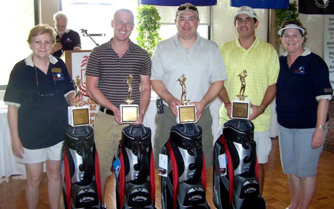 Staff Sgt. Justin Rickles (second from left), 482nd FW Security Forces Squadron, teamed with Dmitri Sandler, Manny Lara and Steve Bateman (not pictured) to win the Greater Homestead/Florida City Chamber of Commerce Military Affairs Committee Golf Tournament. Sharon Wilson (left), Combank Mortgage Company president and MAC chairwoman, and Susan Neuman (right) present trophies to the winning team. Altogether, 30 golfers from the 482nd Fighter Wing, U.S. Southern Command and the Florida Air National Guard played alongside civic and business leaders in the 38th annual tournament at the Redland Golf and Country Club on Friday. The tournament is the biggest single fundraising event for the Military Affairs Committee, and proceeds go toward military appreciation programs. (U.S. Air Force photo/Tim Norton)