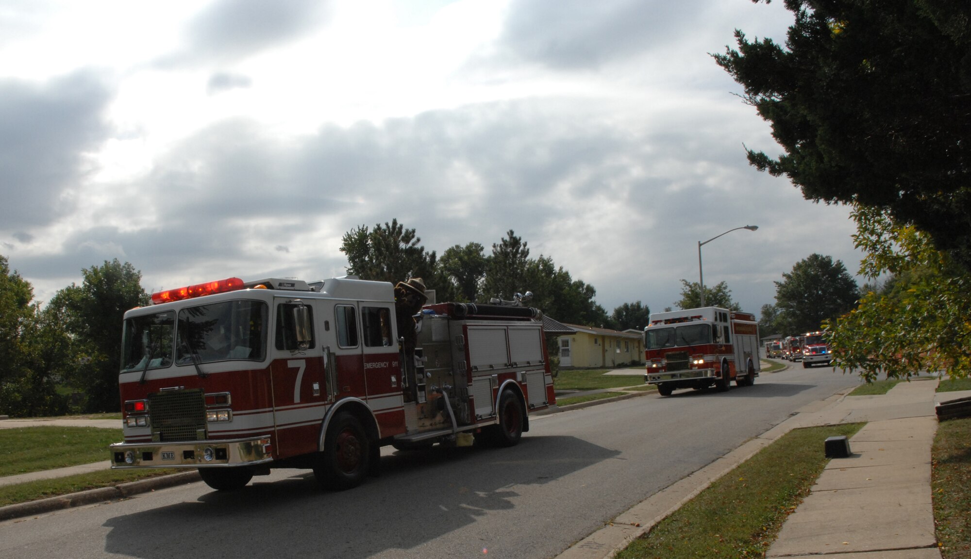 WHITEMAN AIR FORCE BASE, Mo. -- Smokey the Bear waves as the Whiteman Fire Prevention Week Parade goes through base housing with fire trucks from Whiteman and other communities Oct. 7. Whiteman Fire Prevention Week is provided for member of Team Whiteman to know the importance of fire safety Oct. 7 – 13. (U.S. Air Force photo/Airman 1st Class Stephen Linch)