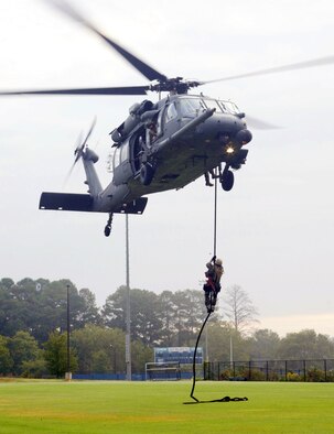 Marietta High School hosted the first "High School Drop-In" event during Air Force Week Atlanta, Oct. 8-14. The helicopter pararescue demonstration was performed by the 301st Rescue Squadron, Patrick AFB, Fla. The aircraft used in the demonstration is the HH-60 Pavehawk. "This demonstration was an alternate infiltration/exfiltration exercise," said Master Sgt. Steve Johnson, the Pavehawk's flight engineer. The exercise demonstrated the capability of the pararescueman to retrieve a survivor by hoist. The rescue demonstration is part of the  Air Force "Heritage to Horizons" 60th Anniversary. (U.S. Air Force photo/Don Peek)