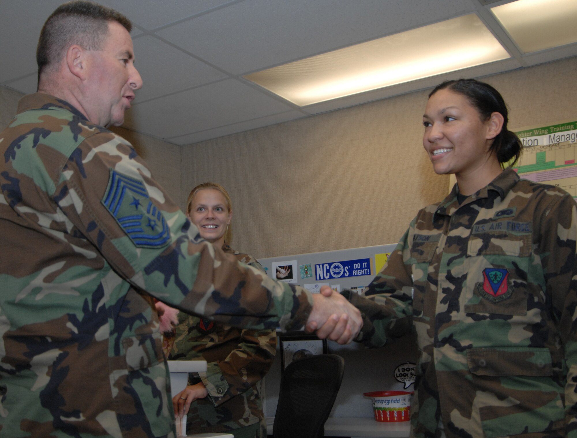 MOUNTAIN HOME AIR FORCE BASE, Idaho--366 Fighter Wing Command Chief Master Sergeant  Allen Niksich, ,  presents a coin to Airman Charalene Watson, 366 Equipment Maintenance Squadron, for winning the command chief for a day contest here, Oct. 5.  CCM for a day is a new program in which new Airmen can experience what it is like to be the wing command chief. (Air Force photo/ Airman 1st Class Stephany Miller)