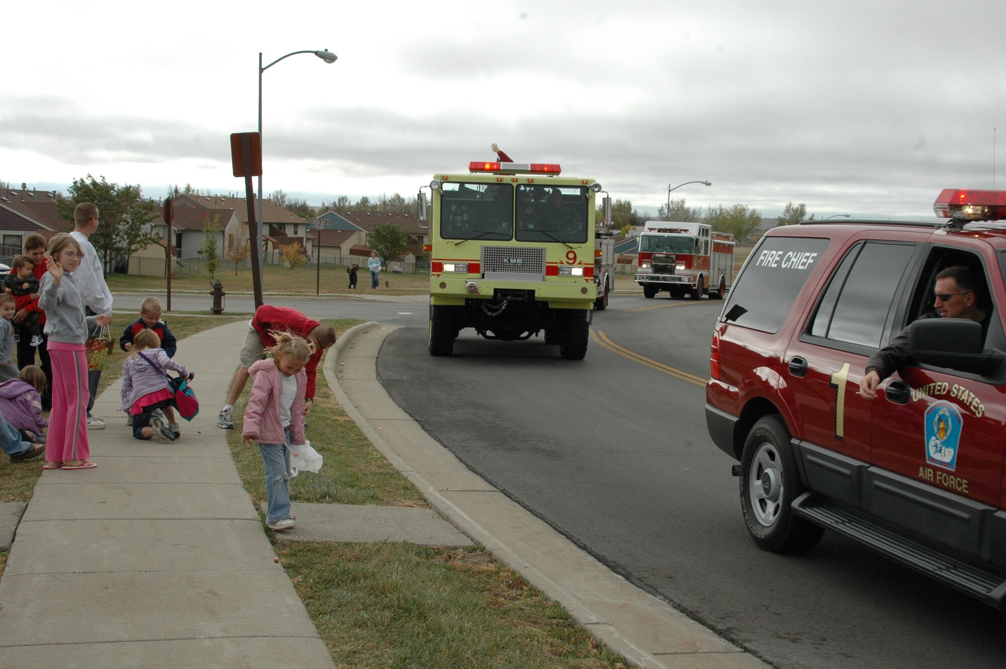 Col. Scott Vander Hamm, 28th Bomb Wing commander throws candy to Ellworth children from the lead vehicle of the Fire Prevention Week parade. A parade was held Oct. 6 to kick off Fire Prevention Week, this year's theme is Practice Your Escape Plan.
(U.S. Air Force photo/Airman 1st Class Kimberly Moore Limrick)