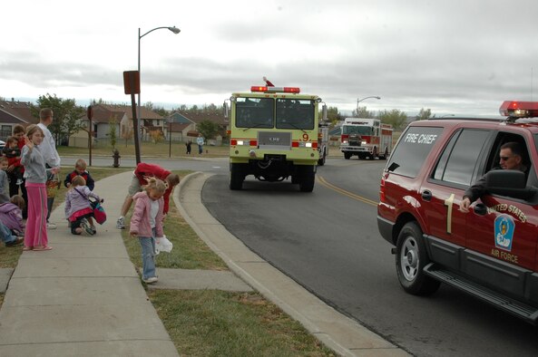 Col. Scott Vander Hamm, 28th Bomb Wing commander throws candy to Ellworth children from the lead vehicle of the Fire Prevention Week parade. A parade was held Oct. 6 to kick off Fire Prevention Week, this year's theme is Practice Your Escape Plan.
(U.S. Air Force photo/Airman 1st Class Kimberly Moore Limrick)