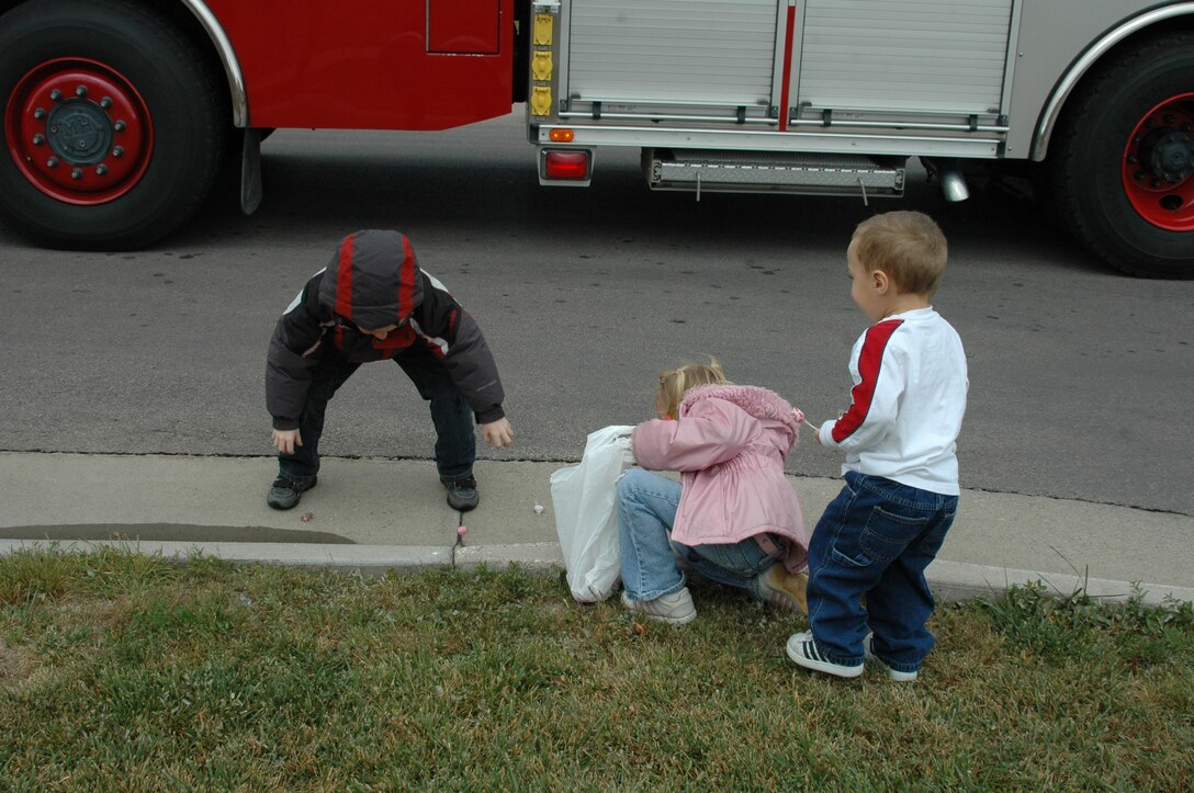 Ellsworth children gather candy that was thrown to them during the Fire Prevention Week Parade. The parade was followed by an open house at the Fire Department. This year's theme is Practice your Escape Plan.
(U.S. Air Force photo/Airman 1st Class Kimberly Moore Limrick)