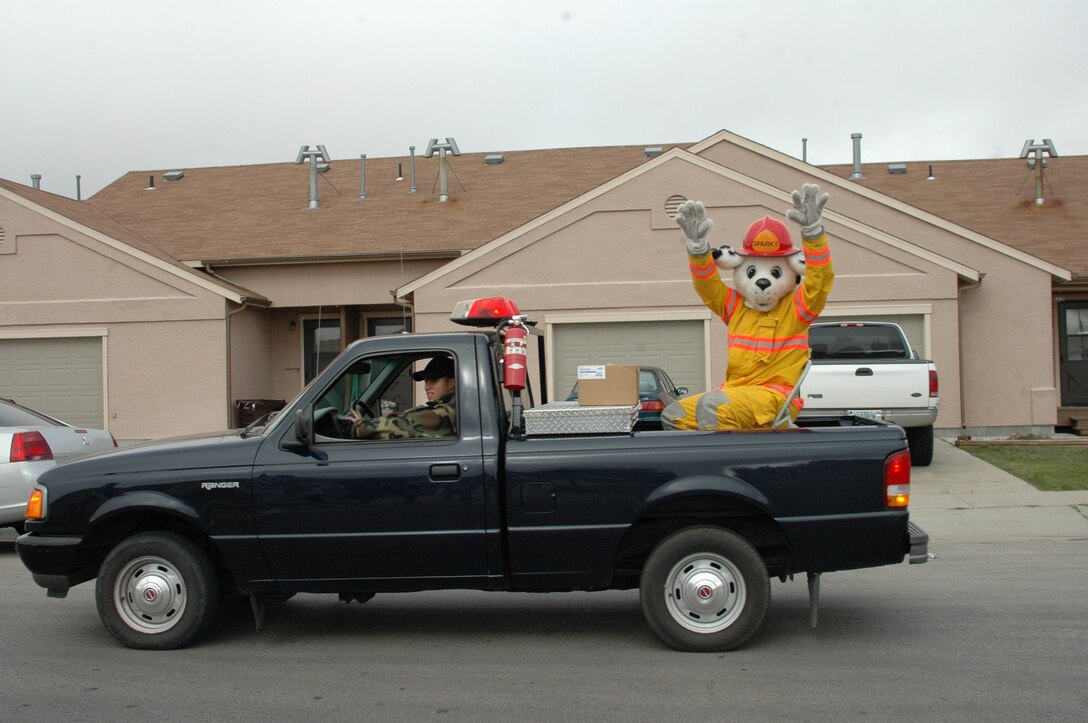 Sparky waves to the crowd during the Fire Prevention Week Parade. The parade was followed by an open house at the Fire Department. This year's theme is Practice your Escape Plan.
(U.S. Air Force photo/Airman 1st Class Kimberly Moore Limrick)
