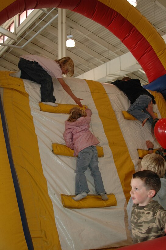 Children lend a helping hand to little ones so they too can enjoy the enflatable slide inside the fire department during an open house Oct. 6. The open house was preceeded by a Fire Prevention Week Parade. This year's theme is Practice your Escape Plan.
(U.S. Air Force photo/Airman 1st Class Kimberly Moore Limrick)