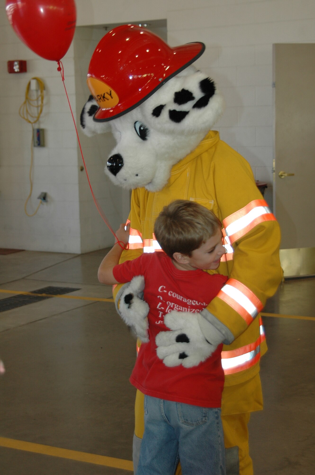 Sparky gets a hug from an admiring child during an open house at the fire department Oct. 6. The open house was preceeded by a Fire Prevention Week Parade. This year's theme is Practice your Escape Plan.
(U.S. Air Force photo/Airman 1st Class Kimberly Moore Limrick)
