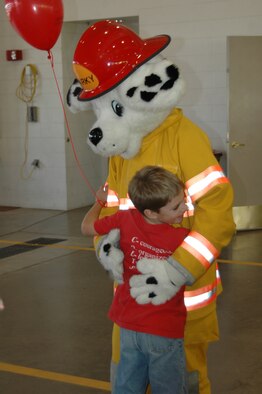 Sparky gets a hug from an admiring child during an open house at the fire department Oct. 6. The open house was preceeded by a Fire Prevention Week Parade. This year's theme is Practice your Escape Plan.
(U.S. Air Force photo/Airman 1st Class Kimberly Moore Limrick)