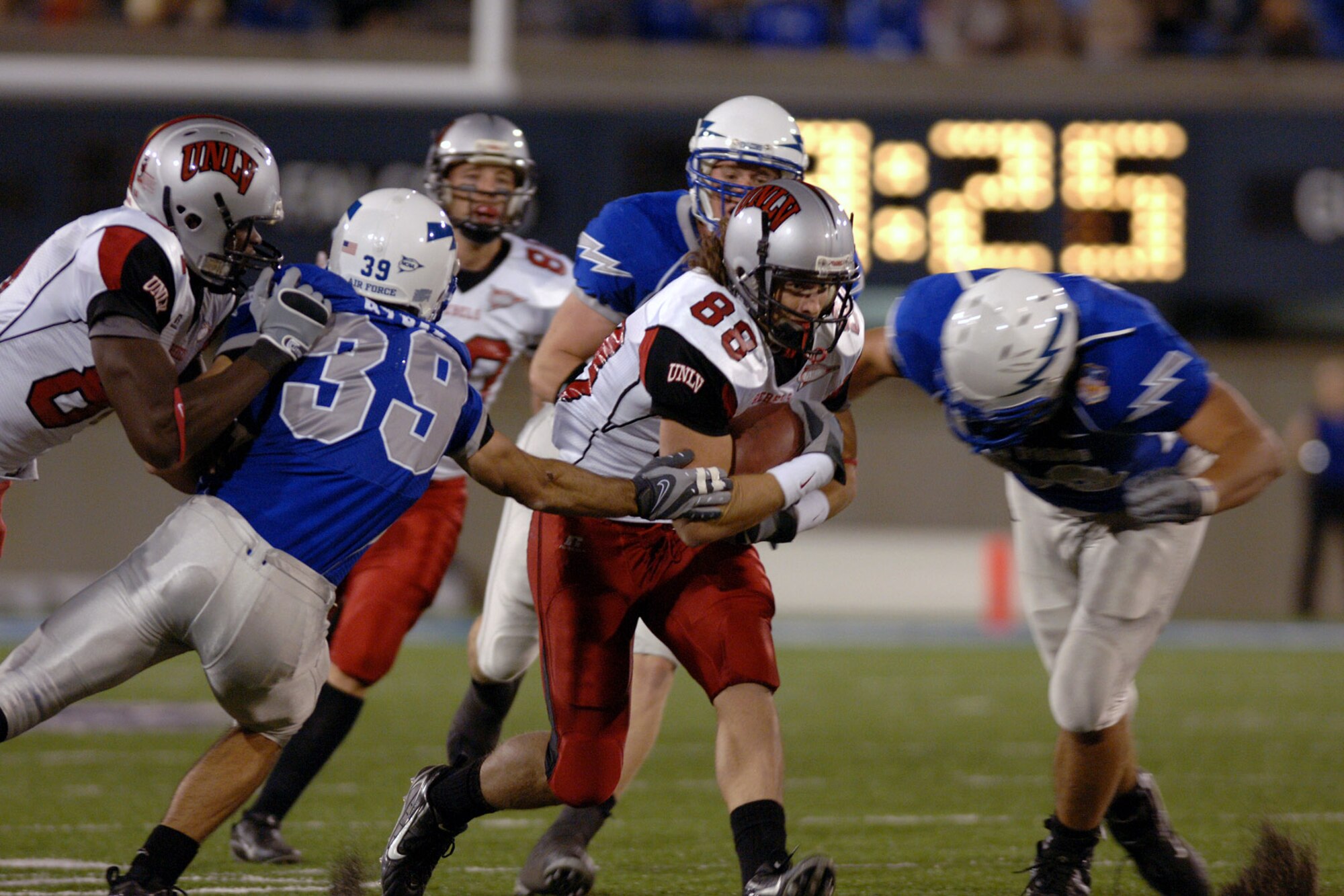 Air Force cornerback Garrett Rybak, 39, and two teammates close in on UNLV wide receiver Ryan Wolfe during the Falcons 31-14 win over UNLV Oct. 6 at Falcon Stadium. Rybak posted four tackles in the game. (U.S. Air Force photo/Dave Armer) 