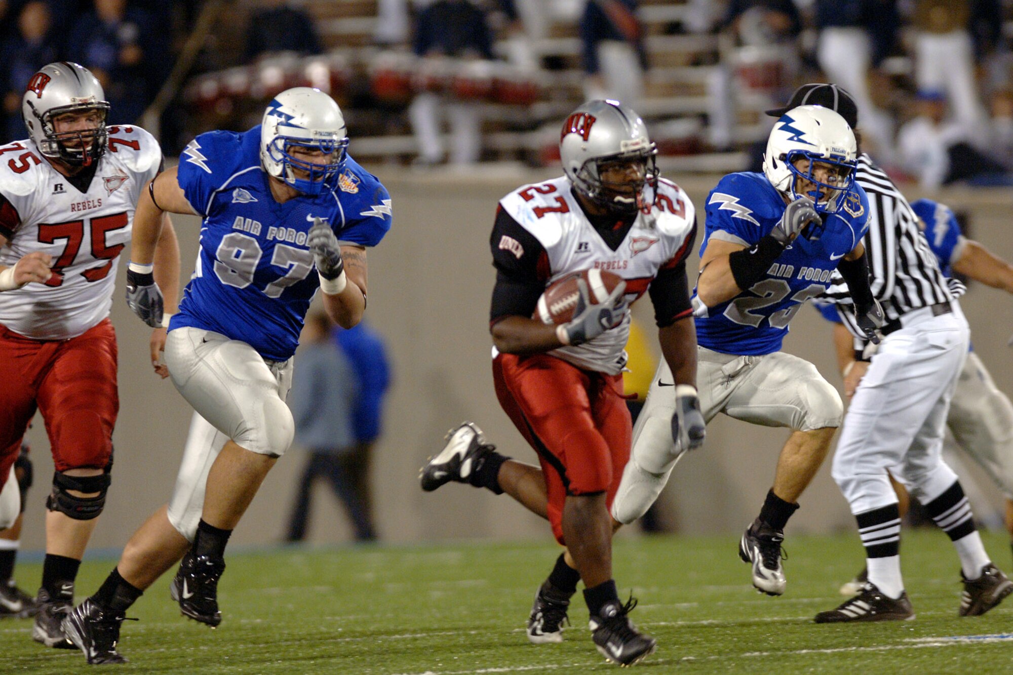 Air Force Defensive end Josh Clayton, 97, and free safety Aaron Kirchoff pursue UNLV running back Chris Brogdon during the Falcons 31-14 victory over the Rebels. Brogdon ran for 28 yards on the play. (U.S. Air Force photo/Dave Armer) 
