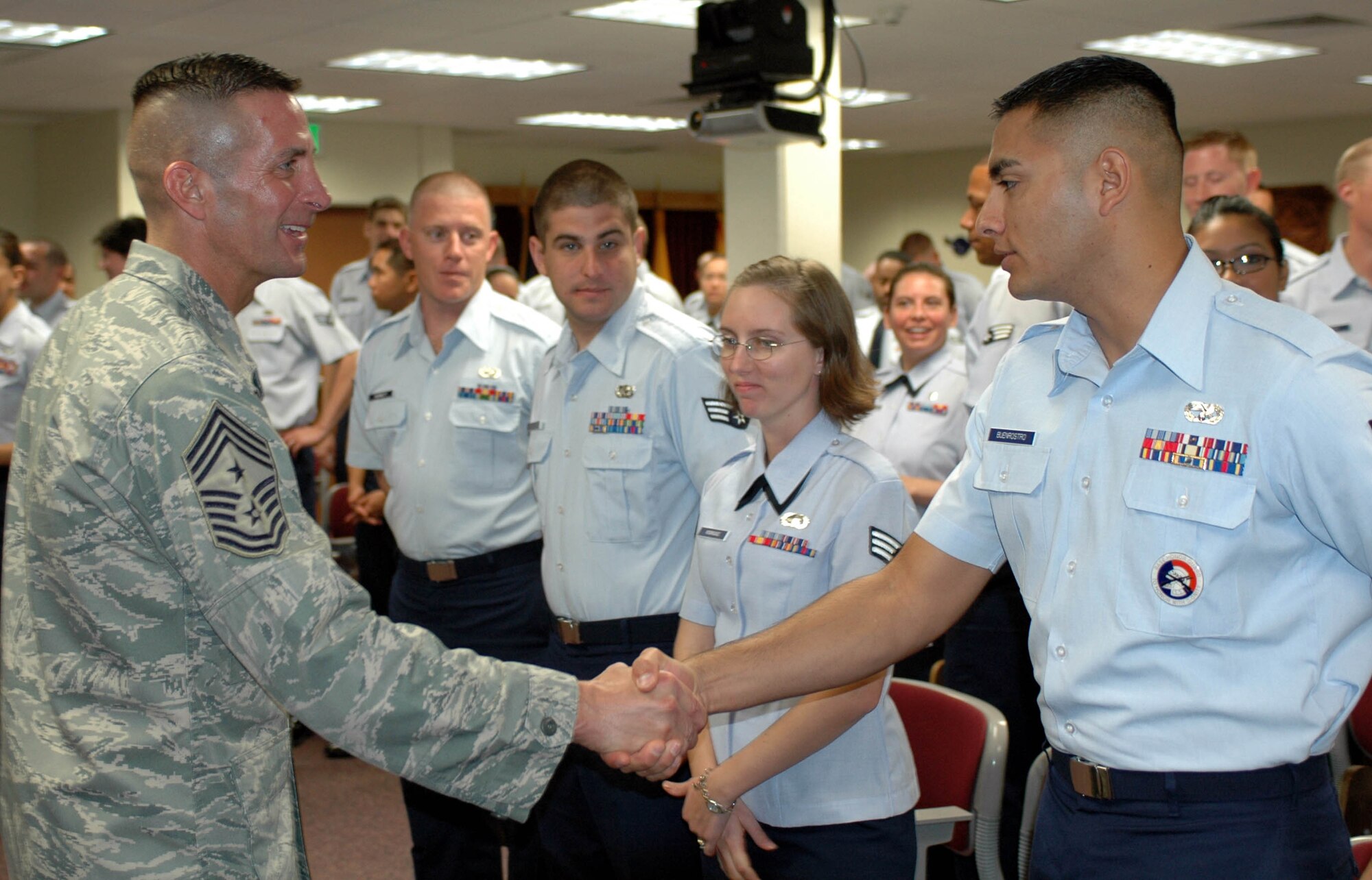 Chief Master Sgt. Joe Barron, command chief of Air Mobility Command, greets students at the Sgt. Paul Ramoneda Airman Leadership School Oct. 2. Chief Barron met with Airmen from all enlisted ranks to discuss some various issues affecting them. (U.S. Air Force photo/Tech. Sgt. Donald Osborn)