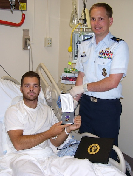 LACKLAND AIR FORCE BASE, TEXAS -- Senior Airman Mark Brown, 91st Missile Security Forces Squadron, poses with his purple heart medal while recovering at Wilford Hall Medical Center. Airman Brown was awarded the purple heart after being wounded in an improvised explosive device attack in Iraq. (courtesy photo)