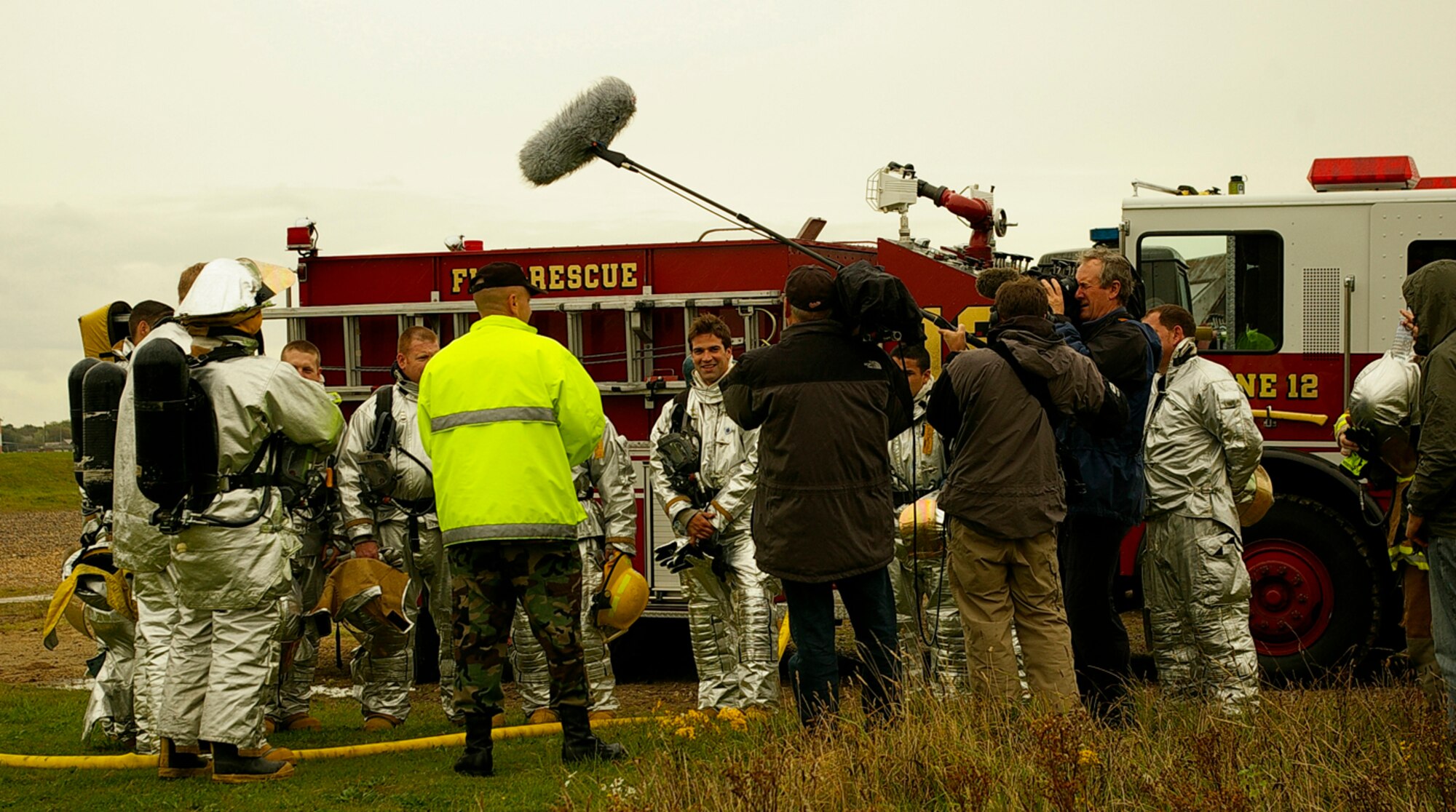 Members from the 100th Civil Engineer Squadron Fire Department receive a safety briefing before entering the smoke-house Oct.1. The firefighters were being filmed by a camera crew from British television channel, BBC1, for children's TV program, "Blue Peter," and were joined by TV presenter, Gethin Jones, who trained alongside them. (U.S. Air Force photo by Karen Abeyasekere)