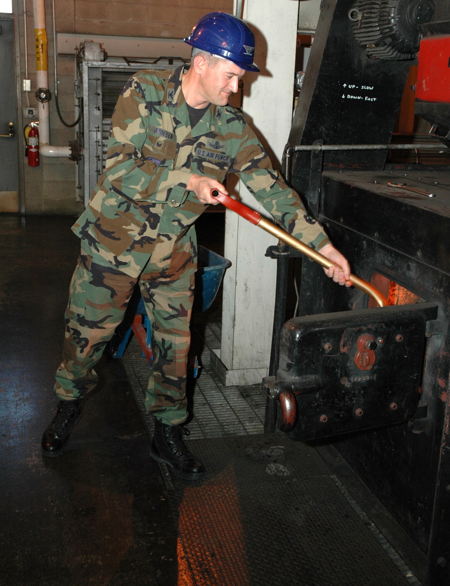 Col. Paul Gydesen, 341st Space Wing vice commander, shovels coal into the coal-fired heat plant at Malmstrom following his first tour of the facility Oct. 3. The plant is closed during summer months and re-opens in the fall to heat the buildings on Malmstrom with hot water. (U.S. Air Force photo/Airman 1st Class DIllon White) 