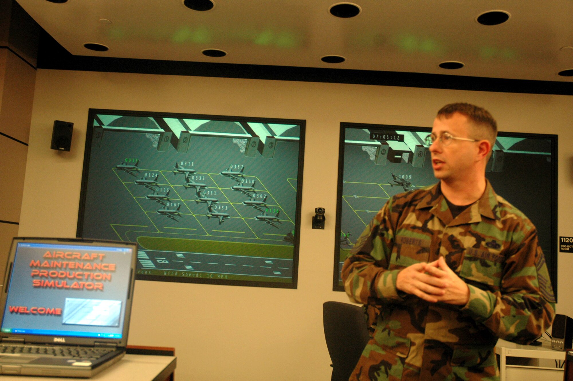 Senior Master Sgt. Paul Roberts, U.S. Air Force Expeditionary Center's Mobility Operations School, demonstrates a new computer based tool, the Aircraft Maintenance Production Simulator, for maintenance leadership courses in the MOS during a tour Aug. 22 at the Center on Fort Dix, N.J.  The new simulator will start to be used by students in October 2007.  (U.S. Air Force Photo/Tech. Sgt. Scott T. Sturkol)