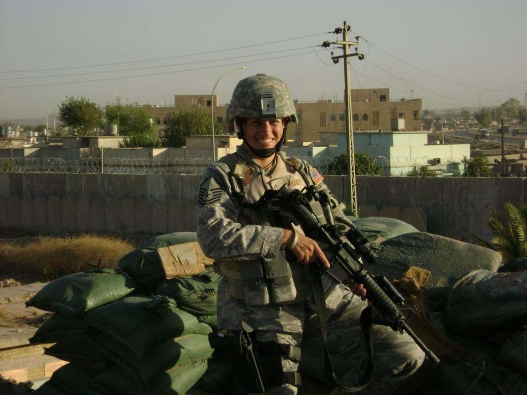 KIRKUK AIR BASE, IRAQ--Master Sgt. Wendy Lopedote stands in front of the city of Kirkuk while on patrol there. Sergeant Lopedote is one of more than forty security forces deployed from the 916th Air Refueling Wing, Air Force Reserve, located at Seymour Johnson Air Force Base, N.C.