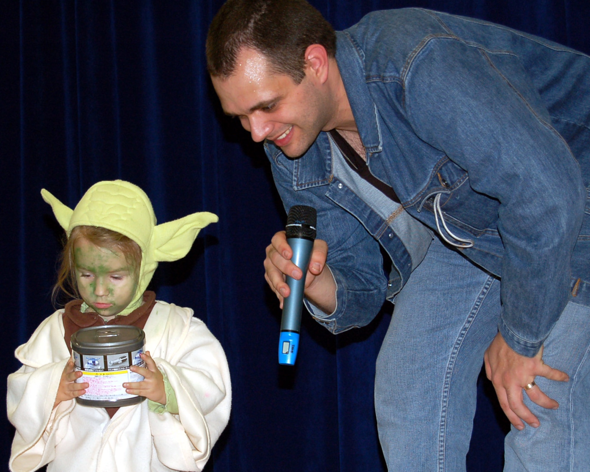 SPANGDAHLEM AIR BASE, Germany -- Senior Airman Jarrod Garceau, 52nd Medical Operations Squadron and Star Wars convention coordinator, awards Reagan Boyett, daughter of Staff Sgt. John Boyett, 52nd Component Maintenance Squadron, the costume contest first prize during a Star Wars convention here celebrating the 30th anniversary of the movie’s release Oct. 6. (U.S. Air Force photo/Staff Sgt. Tammie Moore)  