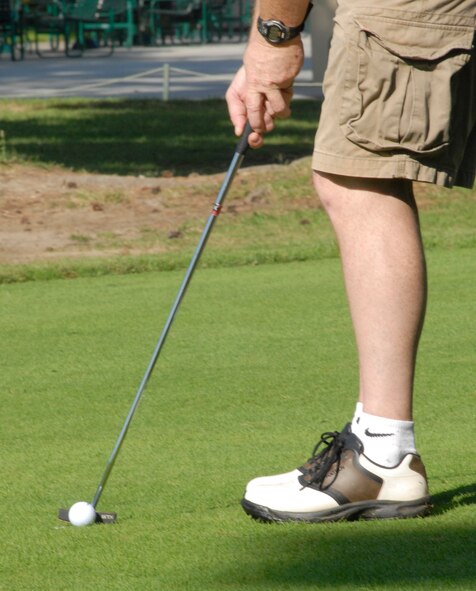 KUNSAN AIR BASE, South Korea - U.S. Air Force Chief Master Sgt. Jeff Repass, lines up for his put on the 9th green during the U.S. Air Force and Republic of Korea Air Force chief’s golf event here Oct 6.  Six USAF chiefs and six ROKAF chiefs met for a friendly game of golf to exchange communication and build friendship. (U.S. Air Force photo/Staff Sgt. Darcie Ibidapo)