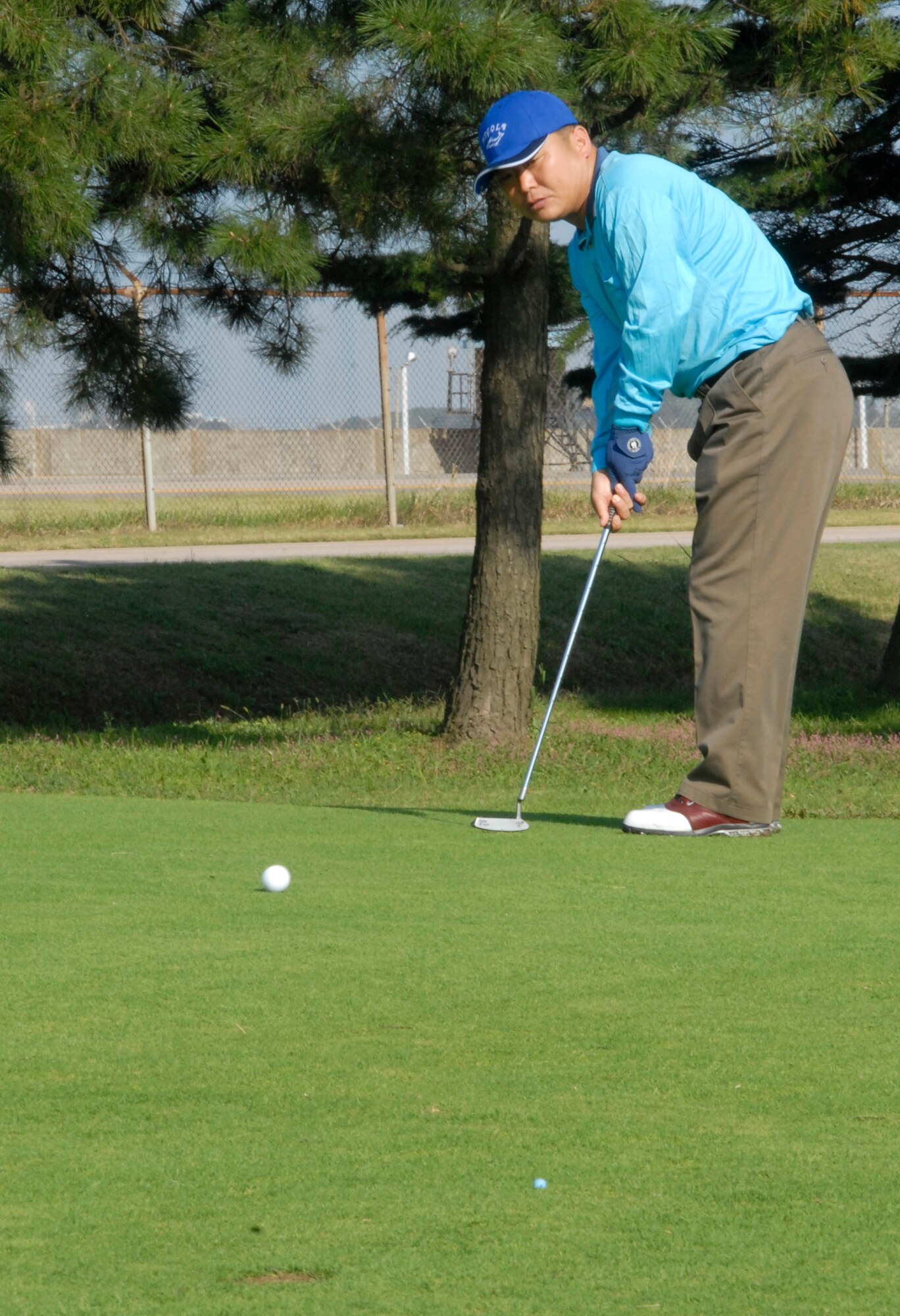 KUNSAN AIR BASE, South Korea - Republic of Korea Air Force Chief Master Sgt. Kudong Yun, puts for par during the U.S. Air Force and Republic of Korea Air Force chief’s golf event here Oct. 6.  Six USAF chiefs and 6 ROKAF chiefs met for a friendly game of golf to exchange communication and build friendship. (U.S. Air Force photo/Staff Sgt. Darcie Ibidapo)