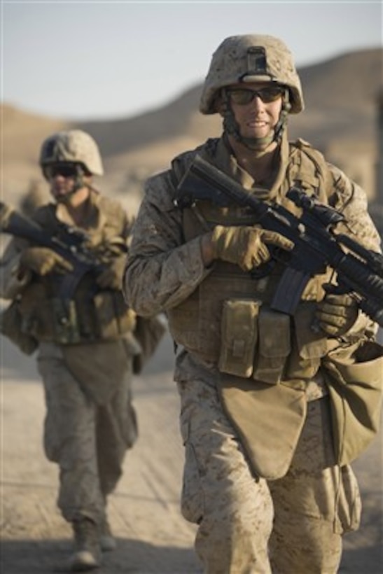 U.S. Marine Corps 2nd Lt. Andrew D. Markoff (right) patrols back to Expeditionary Patrol Base Dulab in Dulab, Iraq, on Sept. 25, 2007.  Markoff is assigned as platoon commander for 1st Platoon, Alpha Company, 1st Battalion, 7th Marine Regiment.  The Marines are working with Iraqi police in the Al Anbar province of Iraq.  