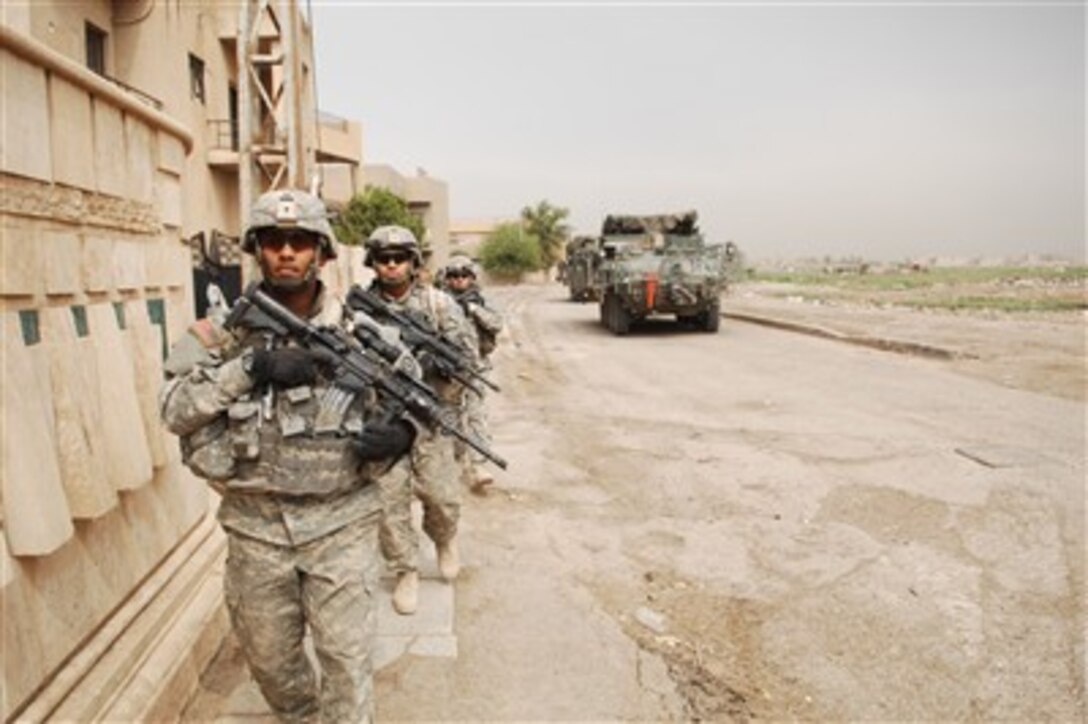 U.S. Army soldiers with 2nd Stryker Cavalry Regiment move to their next objective during a focused search in Baghdad, Iraq, on Oct. 7, 2007.  