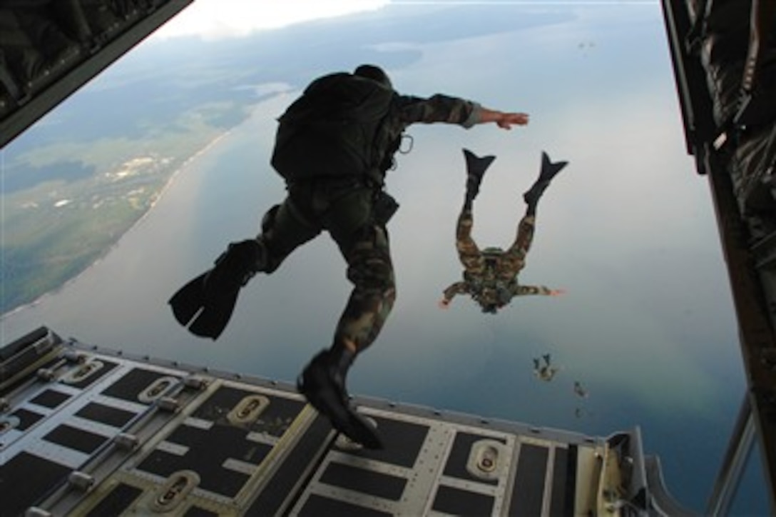 U.S. Air Force airmen from the 720th Special Tactics Group jump out of a C-130J Hercules aircraft during water rescue training over the Destin coastline in Florida on Oct. 3, 2007.  The training is designed to enhance aerial zodiac deployment and personnel recovery.  