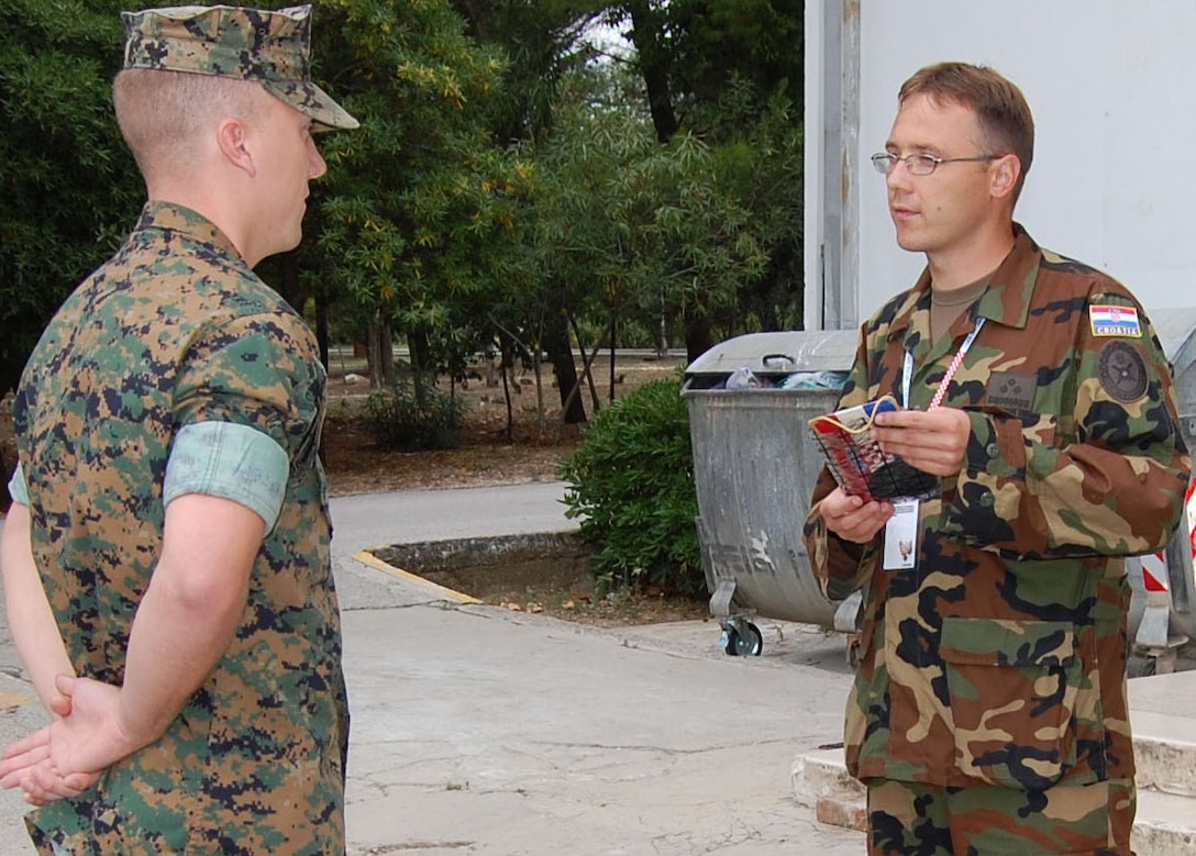 DIVULJE AIR BASE, CROATIA (Oct. 19, 2007) - Cpl. Kyle J. Strmic, a Croatian embark Marine, is presented a Croatian Flag, the patch of the Croatian Army?s 4th Corps of Land Forces and an emblem worn by Capt. Jurica Vukusic, Captain in the 4th Corps of Land Forces at Divulje Air Base, Croatia Oct. 10.  Strmich, along with his fellow embark Marines with 2nd Marine Logistics Group, were deployed to Croatia in support of NATO exercise Noble Midas.  (Official U.S. Marine Corps Photo by: Lance Cpl. Meghan J. McNabb)