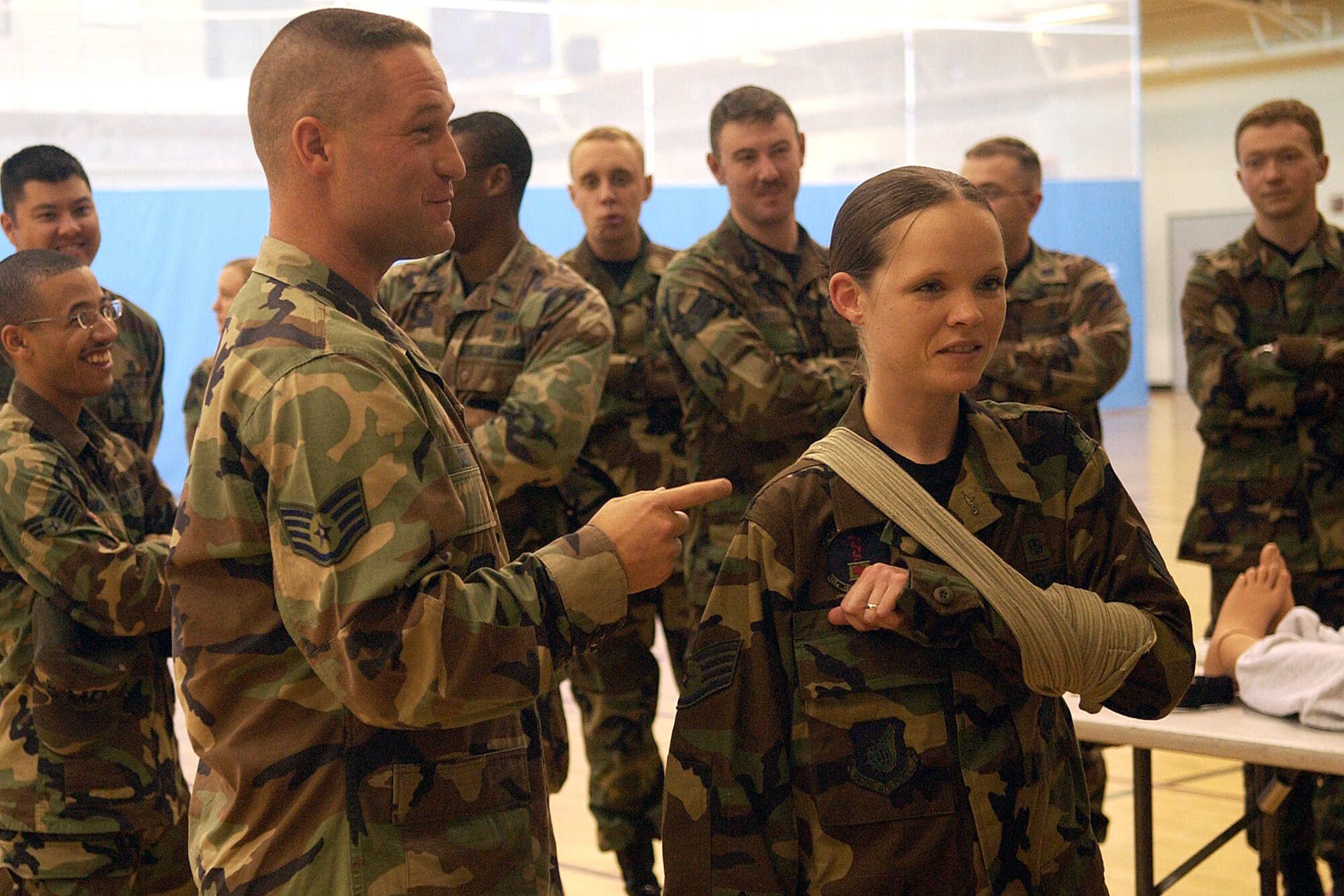 KUNSAN AIR BASE, South Korea - Staff Sgt. Robert Seid from the 8th Logistics Readiness Squadron, and Staff Sgt. Lena Hughes, from the 8th Medical Support Squadron, illustrate the correct procedures of using a tourniquet during the Self Aid Buddy Care class here Oct. 10.  The SABC class was part of the Ability to Survive and Operate Rodeo conducted during the Wolf War Day to prepare newly assigned Airmen for potential combat operations. (U.S. Air Force photo/Senior Airman Giang Nguyen)                                    