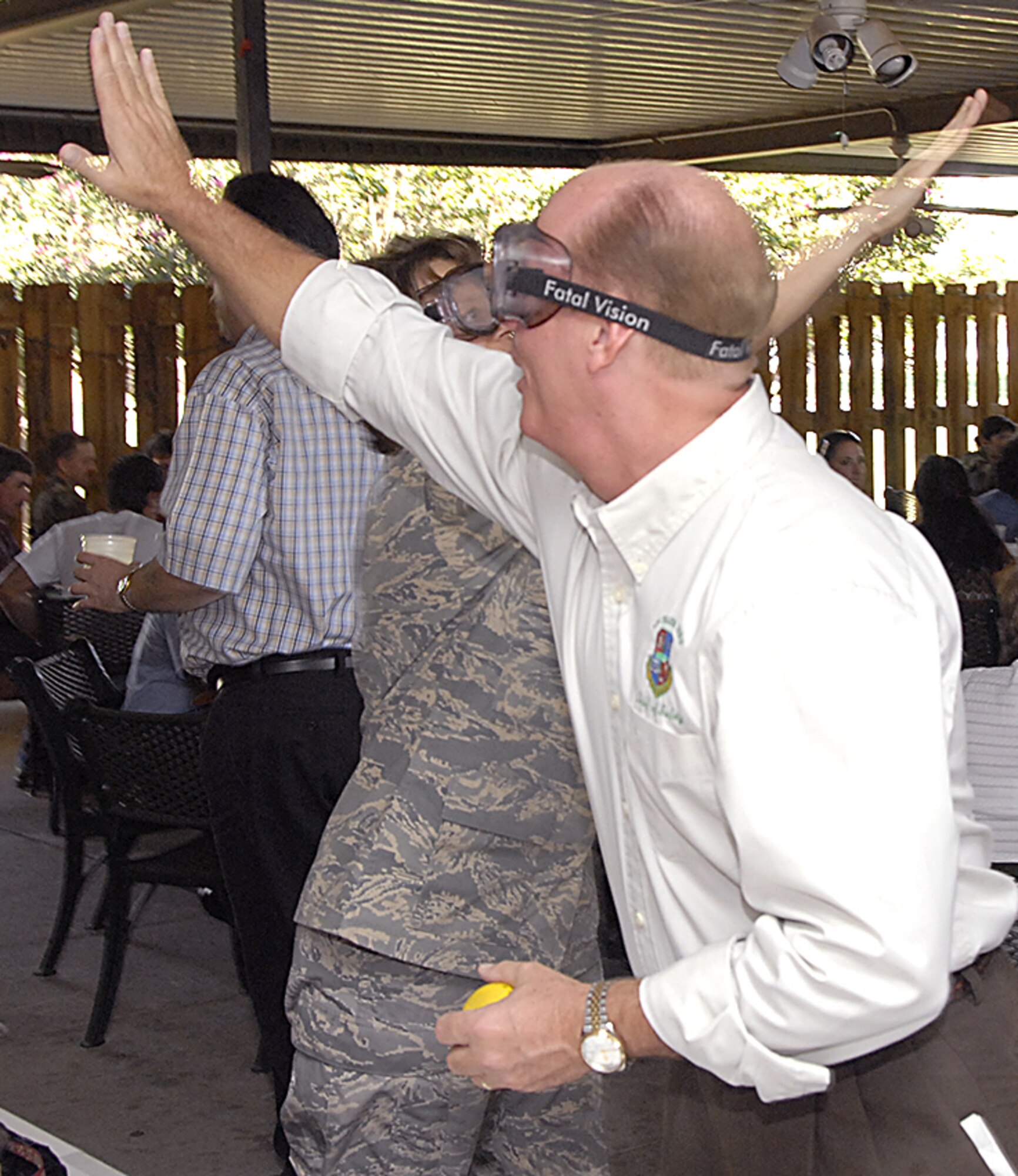 James Zillweger, the 82nd Training Wing Chief of Safety, and 882nd Training Group Commander Col. Nancy Dezell demonstrate Oct. 5 how difficult it is to complete something as simple as a high-five when vision and judgment is impaired at the "DUI Free - Prevention is Key" picnic at the Sheppard Club. Team Sheppard members were rewarded with the Italian-style picnic for going 143 days without a driving under the influence incident, but also urged to refocus as people begin to prepare for the holiday season. (U.S. Air Force photo/Harry Tonemah)