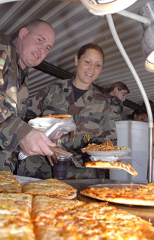 Airman 1st Class Jason Lee, left, and Capt. Tracie Tate get their helping of pizza and spaghetti Oct. 5 at the "DUI Free - Prevention is Key" picnic at the Sheppard Club. The event was 82nd Training Wing Commander Brig. Gen. Richard Devereaux's way of saying good job to Sheppard members going 143 days without a driving under the influence incident. It was also an opportunity to refocus on DUI prevention as the holiday seasons approach. (U.S. Air Force photo/Harry Tonemah)