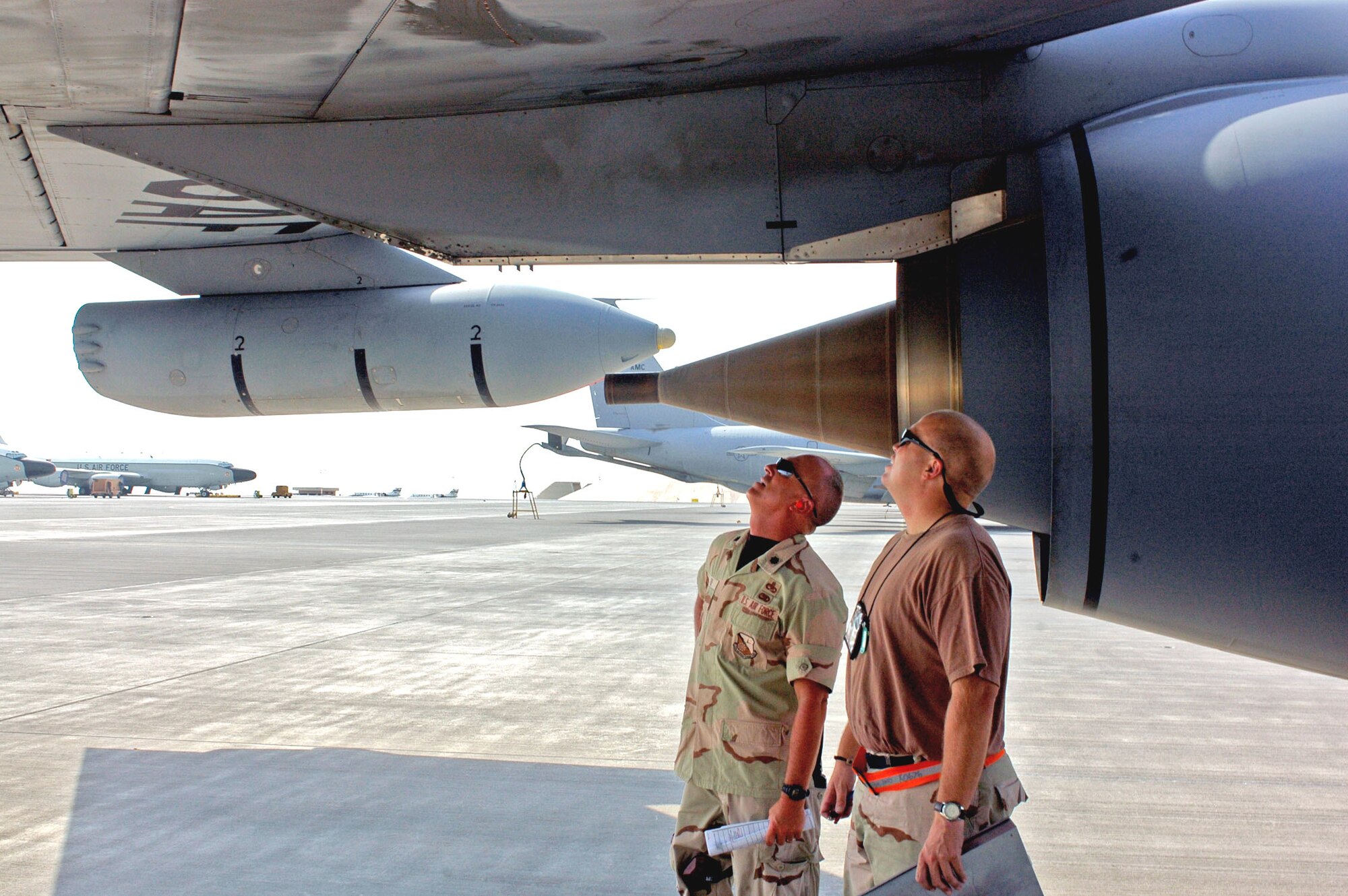 Lt. Col. Scott Fike (left) and Tech. Sgt. Kevin Kuehn analyze a hydraulic fluid leak on a KC-135 Stratotanker in Southwest Asia. The aircraft was venting to relieve pressure caused by excessive heat. Colonel Fike is the 379th Expeditonary Maintenance Group vice commander and Sergeant Kuehn is the 340th Aircraft Maintenance Unit specialist expeditor. (U.S. Air Force photo/Staff Sgt. Jason Barebo) 