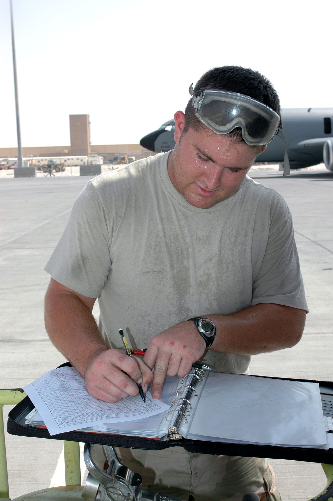 Senior Airman Neal Sicard fills out aircraft forms for a KC-135 Stratotanker in Southwest Asia. The forms provide a record of all maintenance actions performed on the aircraft. Airman Sicard is deployed to the 340th Aircraft Maintenance Unit from Grand Forks Air Force Base, N.D. (U.S. Air Force photo/Staff Sgt. Jason Barebo) 