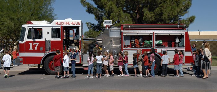 Children from Lomie Heard elementary school at Nellis Air Force Base get an up close look at the Nellis Fire Department's fire truck during fire prevention week on October 10, 2007.  The week's fire prevention activities will culminate with a fun and informational Fire Muster event slated to take place at the Sports Pavilion here Oct. 13 from 7:30 a.m. to approximately 1 p.m.(U.S. Air Force photo by Airman 1st Class Brian Ybarbo)