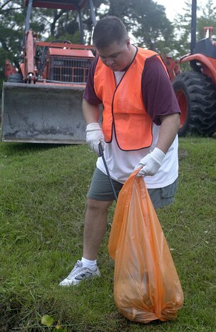 Master Sgt. Art Cormier, 437th Aerial Port Squadron, and Top 3 members picks up trash along the side of Cross-County Road Saturday as part of the Top 3's Adopt-a-Highway Program. (U.S. Air Force photo/Tech. Sgt. Paul Kilgallon)           