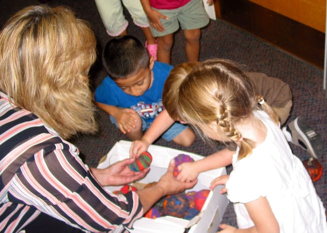 Children from the Charleston AFB Child Development Center help Diane Chancey, 437th Airlift Wing commander's administrative professional, pack up pumpkins they made to be given to veterans at the Ralph H. Johnson VA Medical Center Wednesday. (U.S. Air Force photo/Capt. Michele Lobianco)