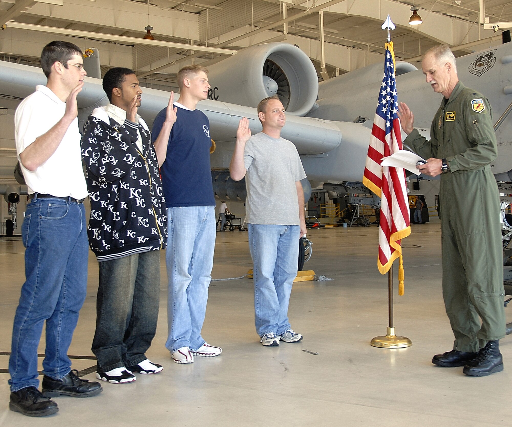 Col Steve Arthur, 442nd Fighter Wing commander, at right, administers the oath of enlistment to four new Air Force Reservists Oct. 10, 2007, at Whiteman Air Force Base, Mo.  The new recruits, Michael Davis, Todd Barton, James Grace and Justin Cagney, took the oath in front of one of the wing's A-10 Thunderbolt II aircraft.  The 442nd FW flies, supports and maintains 24 A-10s, which fly close air support missions in support of ground combat forces.  (U.S. Air Force photo/Master Sgt. William Huntington)