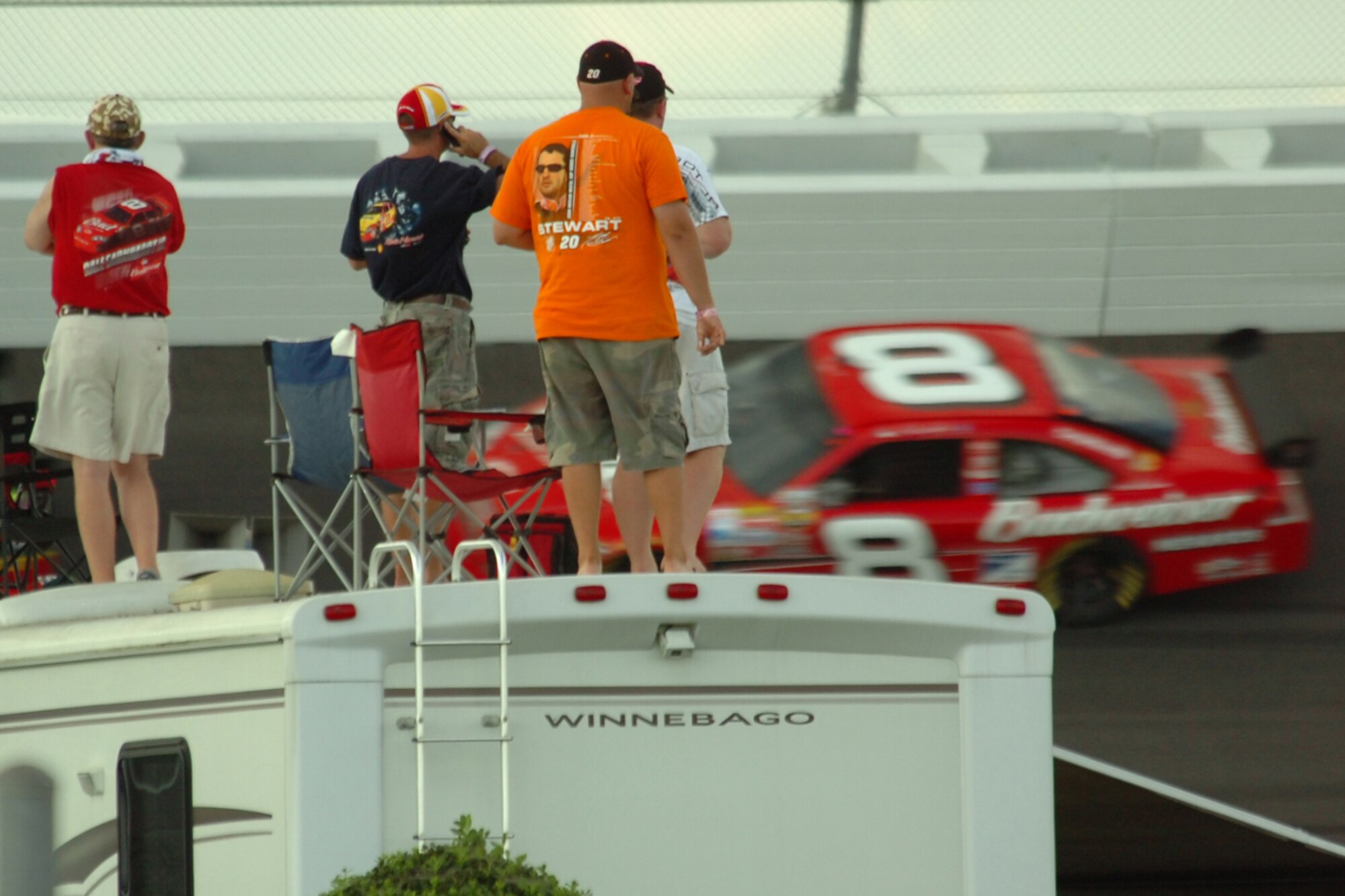 TALLADEGA, Ala. -- Fans stand on the top of their motor home in the exit of Turn 4 getting a bird's eye view of the NASCAR Nextel Cup Series race Oct. 7. John Piccuito, J.R. Suddarth and Tech. Sgt. Jimmy Reed, Eglin Air Force Base firefighters, are among a group of firefighters from all over the country that go to the spring and fall Talladega NASCAR races to make sure the race teams and spectators are safe. They provided safety for the Friday night Automobile Racing Club of America RE/MAX Series race, the NASCAR Craftsman Truck Series race on Saturday and the NASCAR Nextel Cup Series race on Sunday. (U.S. Air Force photo by Staff Sgt. Mike Meares)
