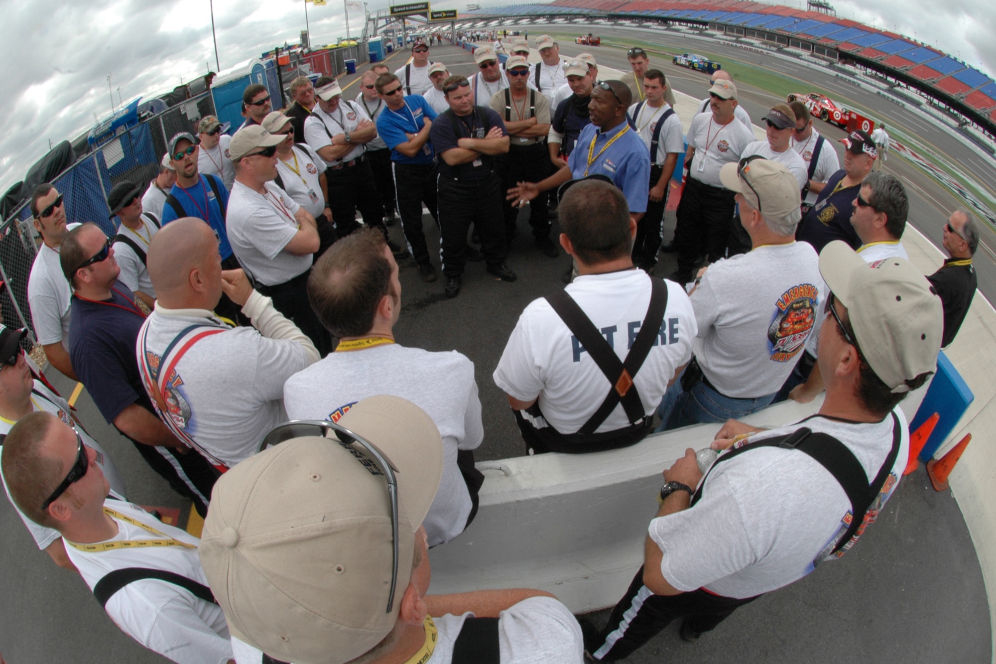 TALLADEGA, Ala. -- The pit fire team gets a briefing before the start of the Automobile Racing Club of America RE/MAX Series race Oct. 5. Included in that team, John Piccuito, J.R. Suddarth and Tech. Sgt. Jimmy Reed, Eglin Air Force Base firefighters, are among a group of firefighters from all over the country that go to the spring and fall Talladega NASCAR races to make sure the drivers and race teams are safe. Sometimes that means protecting the race teams from themselves. They provided safety for the Friday night Automobile Racing Club of America RE/MAX Series race, the NASCAR Craftsman Truck Series race on Saturday and the NASCAR Nextel Cup Series race on Sunday. (U.S. Air Force photo by Staff Sgt. Mike Meares)