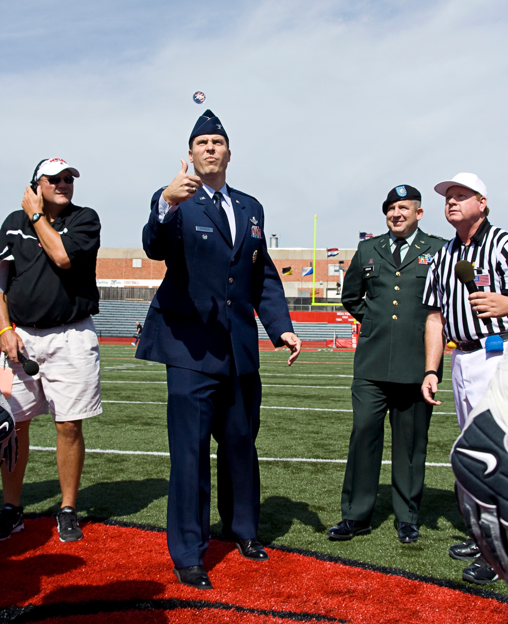 WARRENSBURG, Mo. -- Col. John Robinson, 509th Bomb Wing vice commander, tosses the coin prior to the University of Central Missouri military appreciation day game at Audrey J. Walton Stadium Sept. 29. The UCM Mules lost a heartbreaker, 38 – 31 in double overtime, by the Pittsburg State University Gorillas. (U.S. Air Force photo/1st Lt. Allen Clark) 