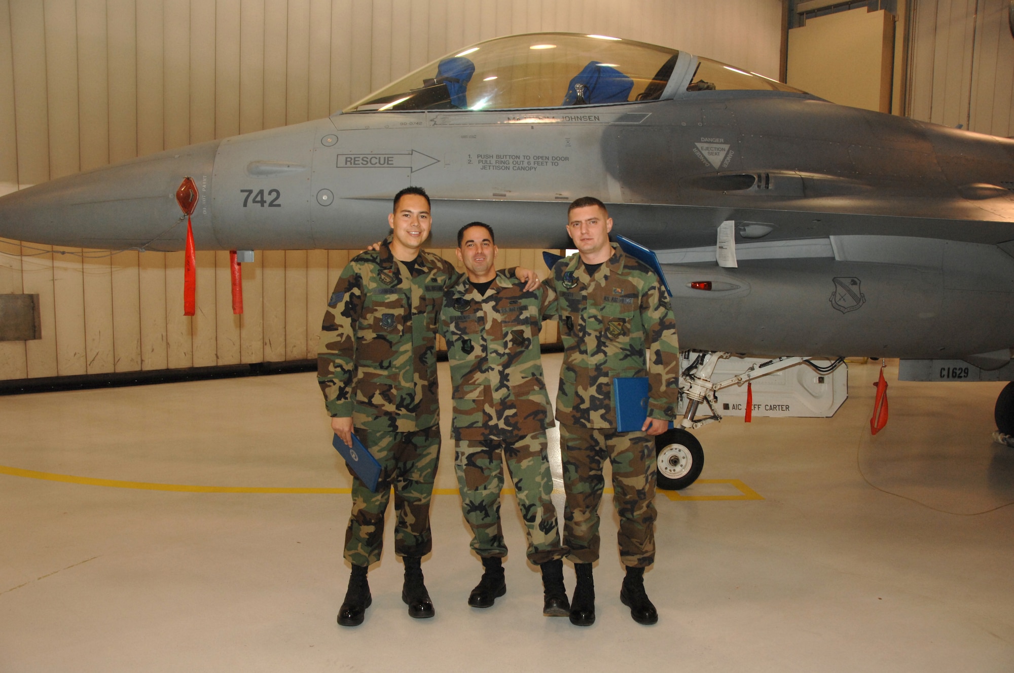 EIELSON AIR FORCE BASE, Alaska --  Staff Sgt. Manuel Sanchez (left), Airman 1st Class Jose Lorenzo (middle), Airman 1st Class Andrew Russell (right), 354th Aircraft Maintenance Squadron and winners of this load competition, stand in front of an F-16 after the Weapons Standardization Load Crew of the Quarter competition Oct. 5, 2007 at the load barn. The Competition evaluates technical proficiency, safety procedures and overall time. (U. S. Air Force photo by Airman 1st Class Christopher Griffin) 