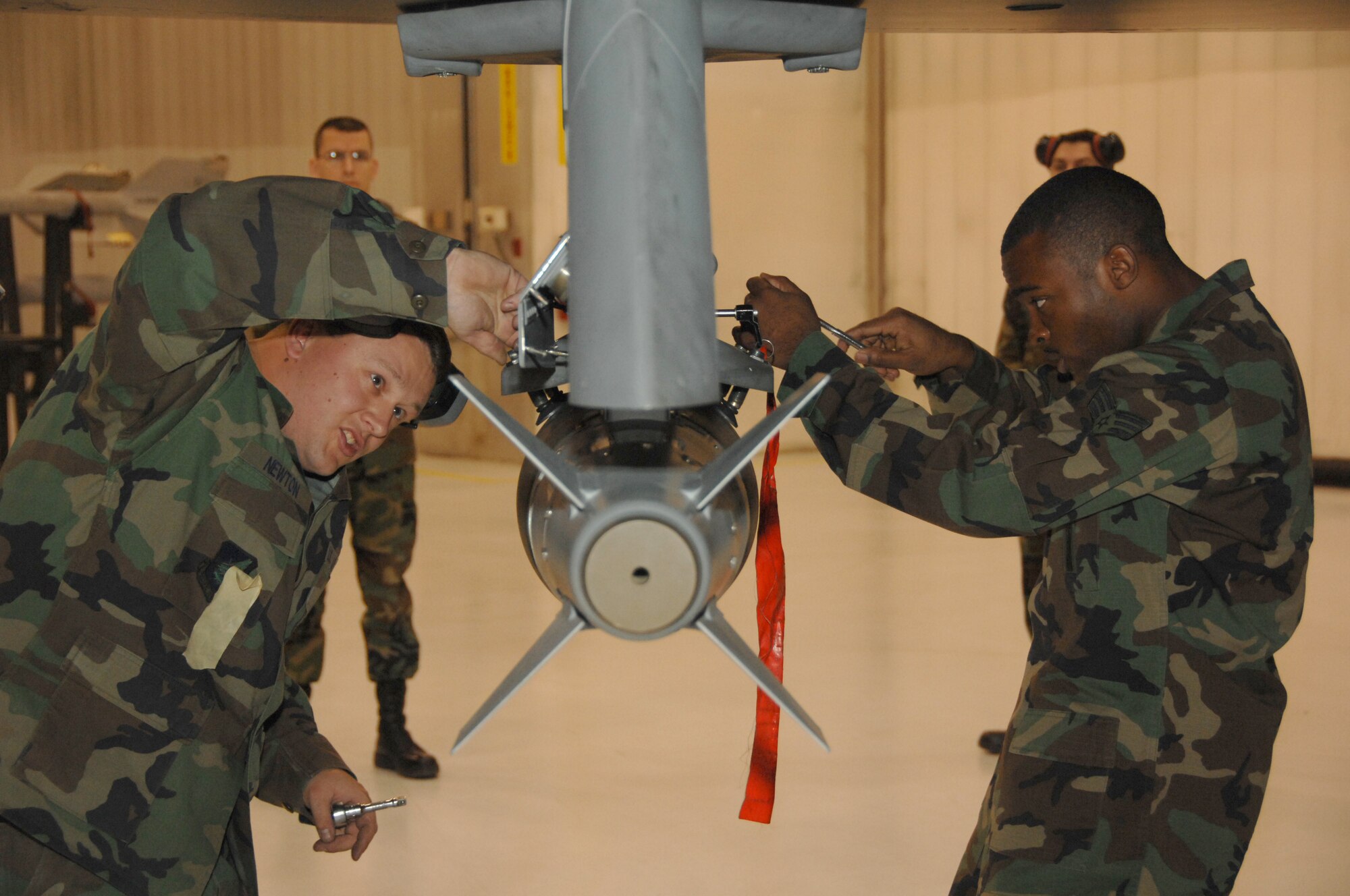 EIELSON AIR FORCE BASE, Alaska --  Staff Sgt. Aaron Newton, Airman 1st Class Corneilius Cutler, 354th Aircraft Maintenance Squadron, load munitions during the Weapons Standardization Load Crew of the Quarter competition Oct. 5, 2007 at the load barn. The Competition evaluates technical proficiency, safety procedures and overall time. The winners of this load competition are Staff Sgt. Manuel Sanchez, Airman 1st Class Jose Lorenzo and Airman 1st Class Andrew Russel. (U. S. Air Force photo by Airman 1st Class Christopher Griffin) 
