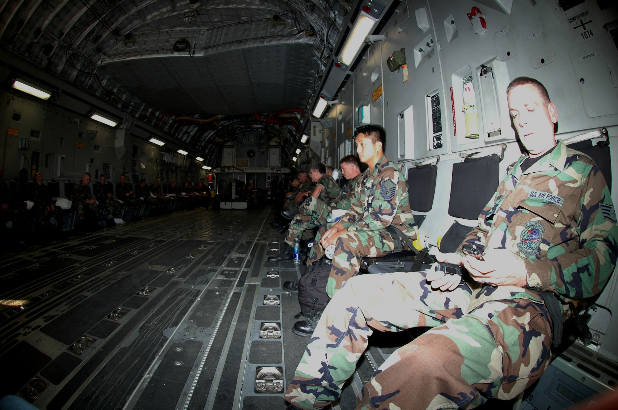 CE MEMBERS DEPLOY FOR SILVER FLAG -- Members of the 439th Civil Engineering Squadron sit aboard a C-17 Globemaster III Oct. 6 at Westover for a flight to Dobbins Air Reserve Base, Ga. The reservists are participating in Silver Flag, one of the largest Air Force exercises in the United States. More than 50 reservists from Westover are involved. The second week of the exercise takes place at Tyndall Air Force Base, Fla.