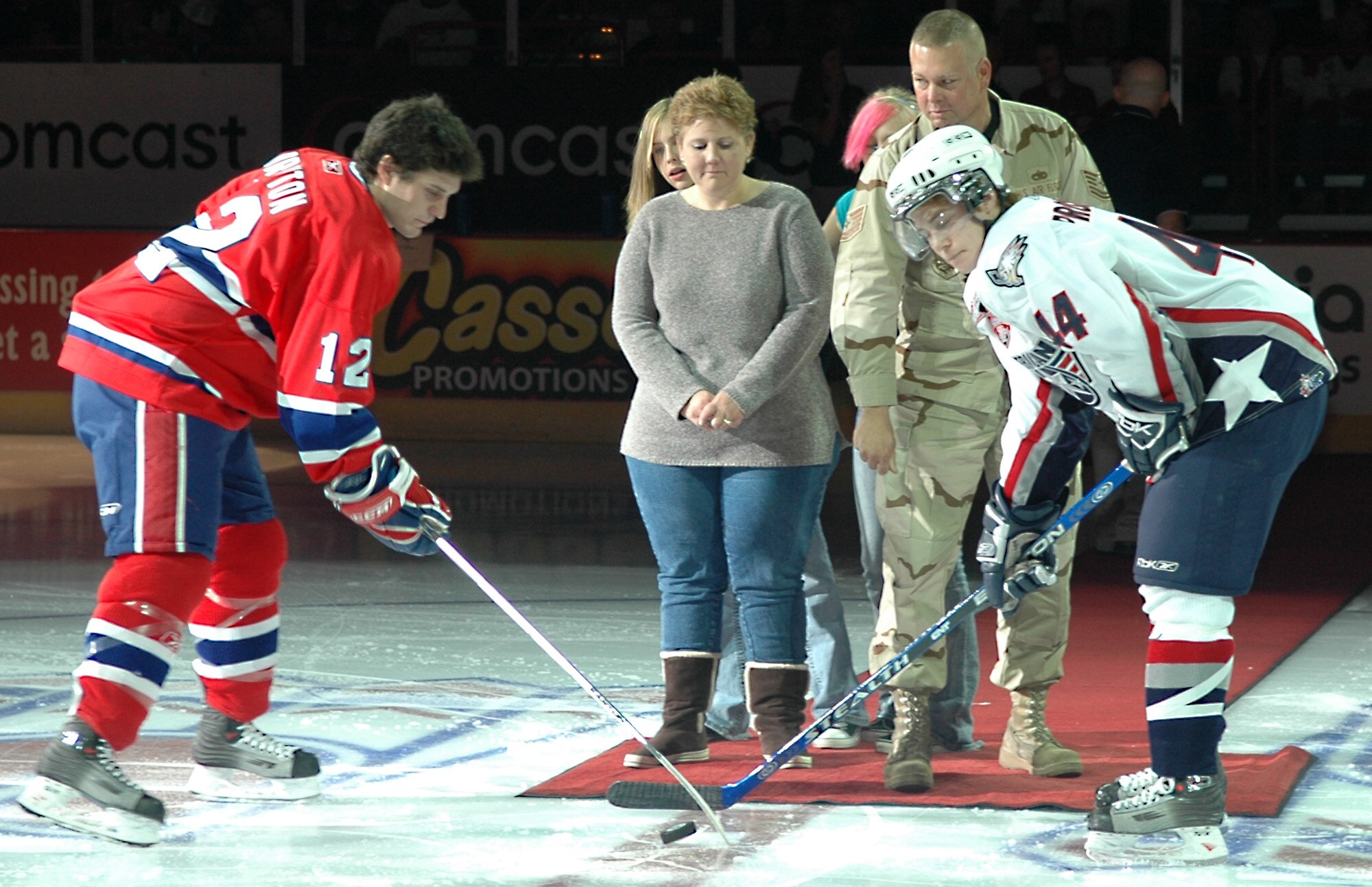 SPOKANE, Wash. – Tech. Sgt. David Robinson, 92nd Aircraft Maintenance Squadron, drops the puck during the Spokane Chiefs home opener against rival Tri-City Americans Oct. 6 at the Spokane Arena. Sergeant Robinson, who returned in September from a deployment, was present on the ice with his wife, Barbara, daughter, Laura, and his daughter’s friend. (U.S. Air Force photo / Airman 1st Class Kali L. Gradishar)