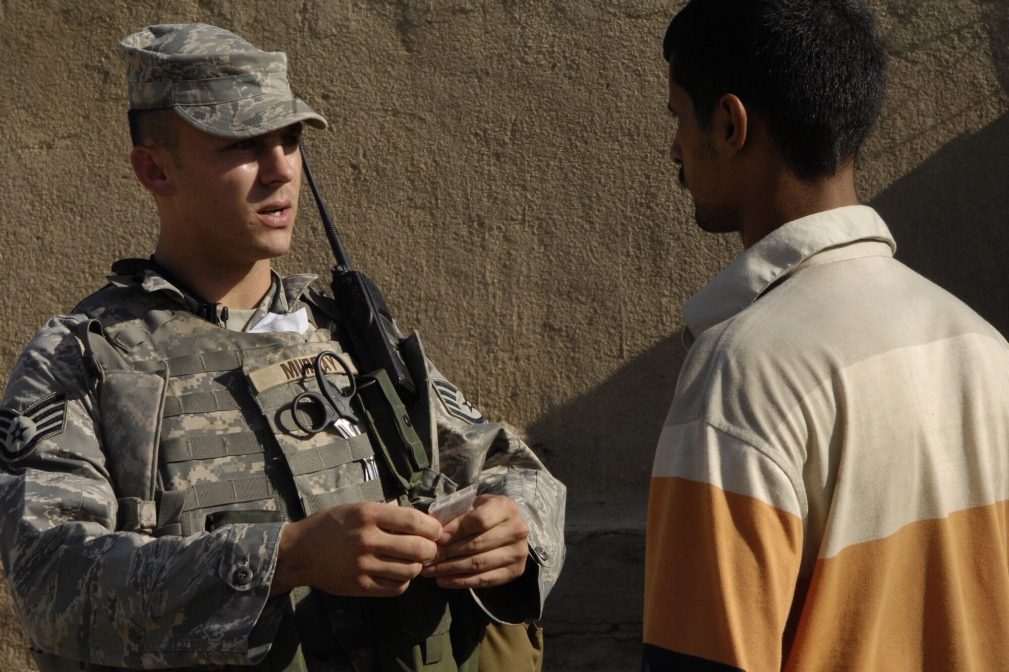 U.S. Air Force Staff Sgt. J.D. Murray, deployed from Lackland AFB, Texas, and assigned to the 732nd Expeditionary Security Forces Squadron, Det. 4, conducts a badge check during a dismounted patrol in an effort to keep escort violations at a minimum in the International Zone. Air Force Security Forces are the first responders for the International Zone, Baghdad, Iraq. They are "in lieu of" tasking, meaning they are filling an Army billet on six-month deployments. (U.S. Air Force photo by Staff Sgt. Angelique Perez)