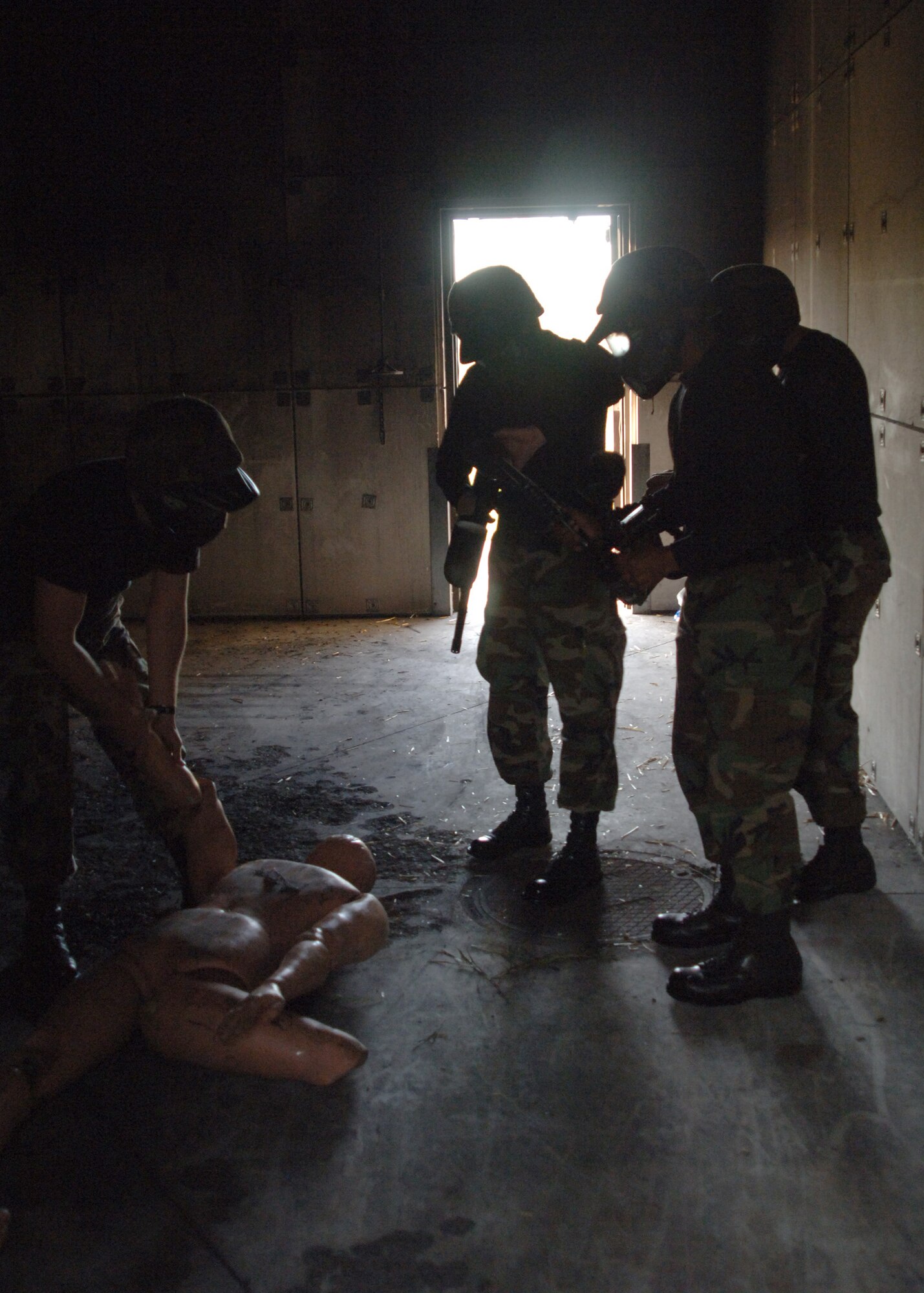Warriors from the 319th Medical Support Squadron, secure a casualty during the Warrior Day Challenge here Sept.28. The Warrior Day Challenge tested Airmen of Grand Forks AFB on their combat readiness through a series of strenuous events including the Air Force physical fitness test, donning Mission Oriented Protective Postures, self aid and buddy care, firearm assembly and knowledge of the Airman's Manual.  (U.S. Air Force photo/Airman 1st Class Chad M. Kellum)