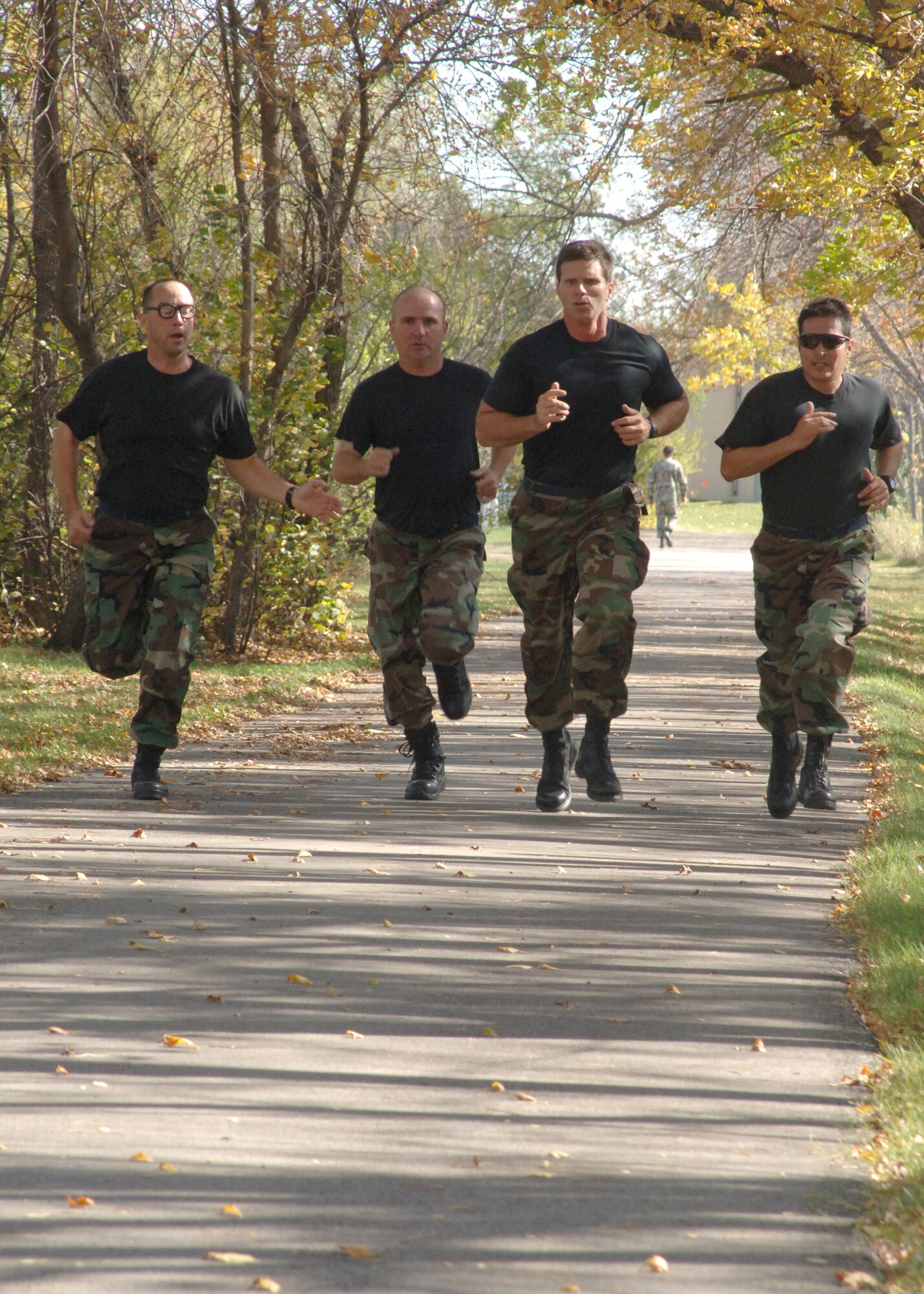 Chief master sergeants from the 319th Air Refueiling Wing race toward the finish line during the sprinting portion of the Warrior Day Challenge here Sept.28. The Warrior Day Challenge tested Airmen of Grand Forks AFB on their combat readiness through a series of strenuous events including the Air Force physical fitness test, donning Mission Oriented Protective Postures, self aid and buddy care, firearm assembly and knowledge of the Airman's Manual.  (U.S. Air Force photo/Airman 1st Class Chad M. Kellum)
