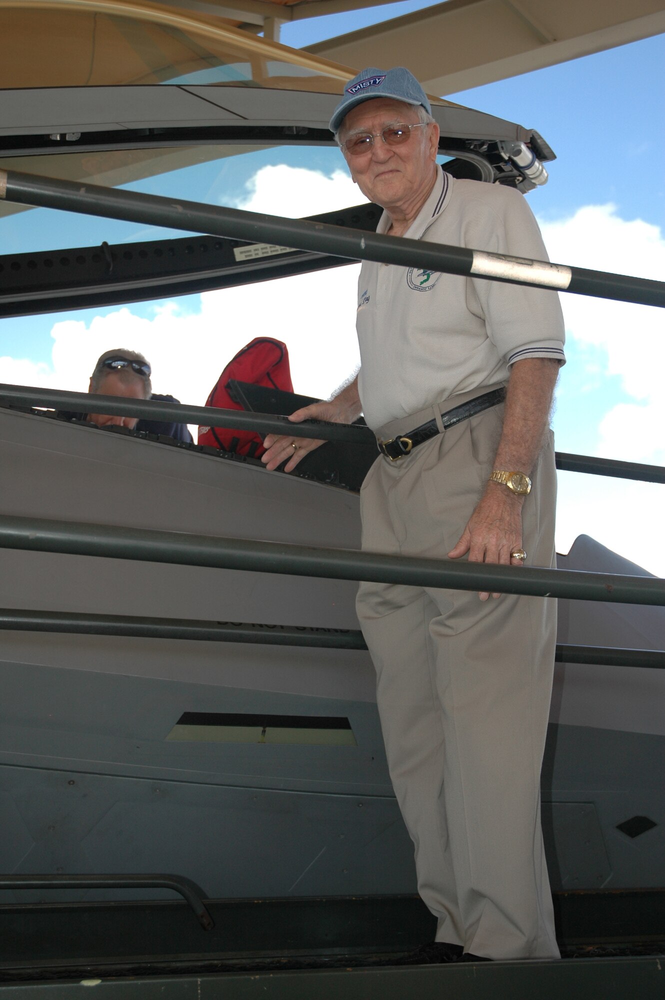 Retired Col. George "Bud" Day examines the cockpit of an F-22 during a tour here Friday.  Mr. Day is the highest decorated living American veteren.