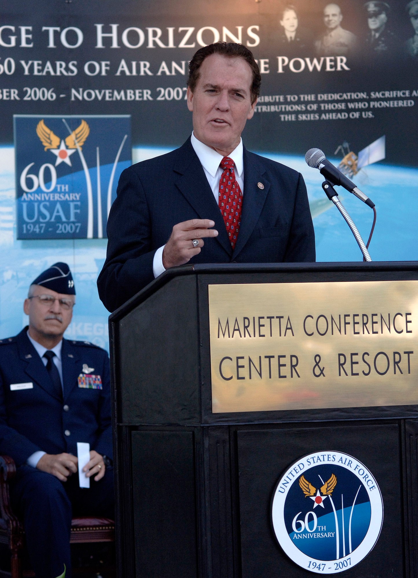 Rep. Phil Gingrey congratulates the Air Force on its 60th anniversary during a proclamation ceremony kicking off Air Force Week Atlanta Oct. 8. The Air Force Week program is meant to increase the awareness and support of the public by informing them and involving them in activities that showcase the Air Force's diverse capabilities and missions, its accomplishments and the sacrifice of its Airmen. Atlanta is one of six cities throughout the country chosen to host an Air Force Week Oct. 8 to 14. The theme for the year is "Heritage to Horizons," celebrating the 60th anniversary of the Air Force, its history and the future of the world's greatest force in air and space.  (U.S. Air Force photo/Staff Sgt. Bennie J. Davis III) 